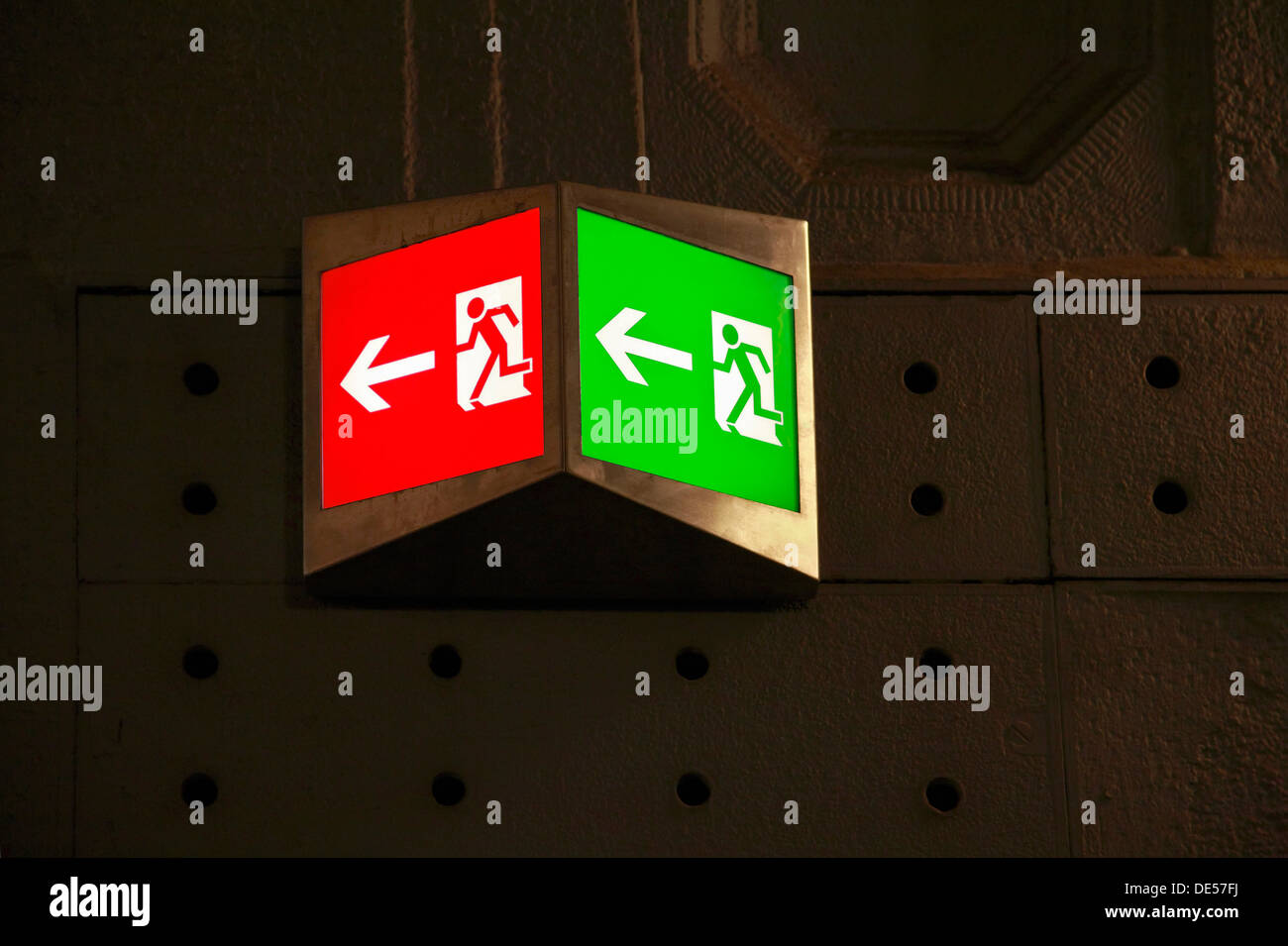 Emergency exit sign, illuminated pictograms, green and red, strange colour, fire prevention, evacuation route Stock Photo