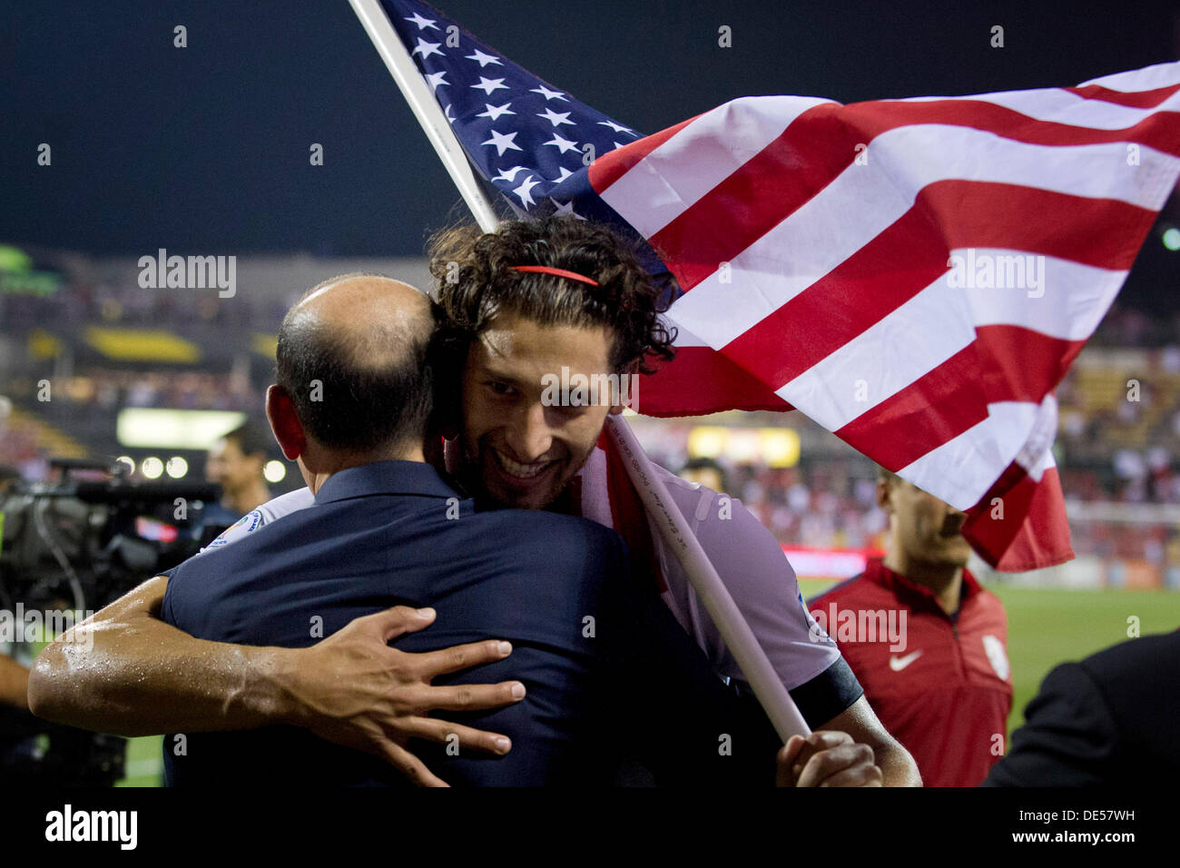 Columbus, Ohio, USA. 10th Sep, 2013. September 10, 2013: US Men's National Team defender Omar Gonzalez (3) holds the American flag and receives a hug after the U.S. Men's National Team defeated The Mexico National Team 2-0 during a - World Cup Qualifier match at Columbus Crew Stadium - Columbus, OH. The United States Men's National Team clinched a spot for the World Cup in Brazil. © csm/Alamy Live News Stock Photo