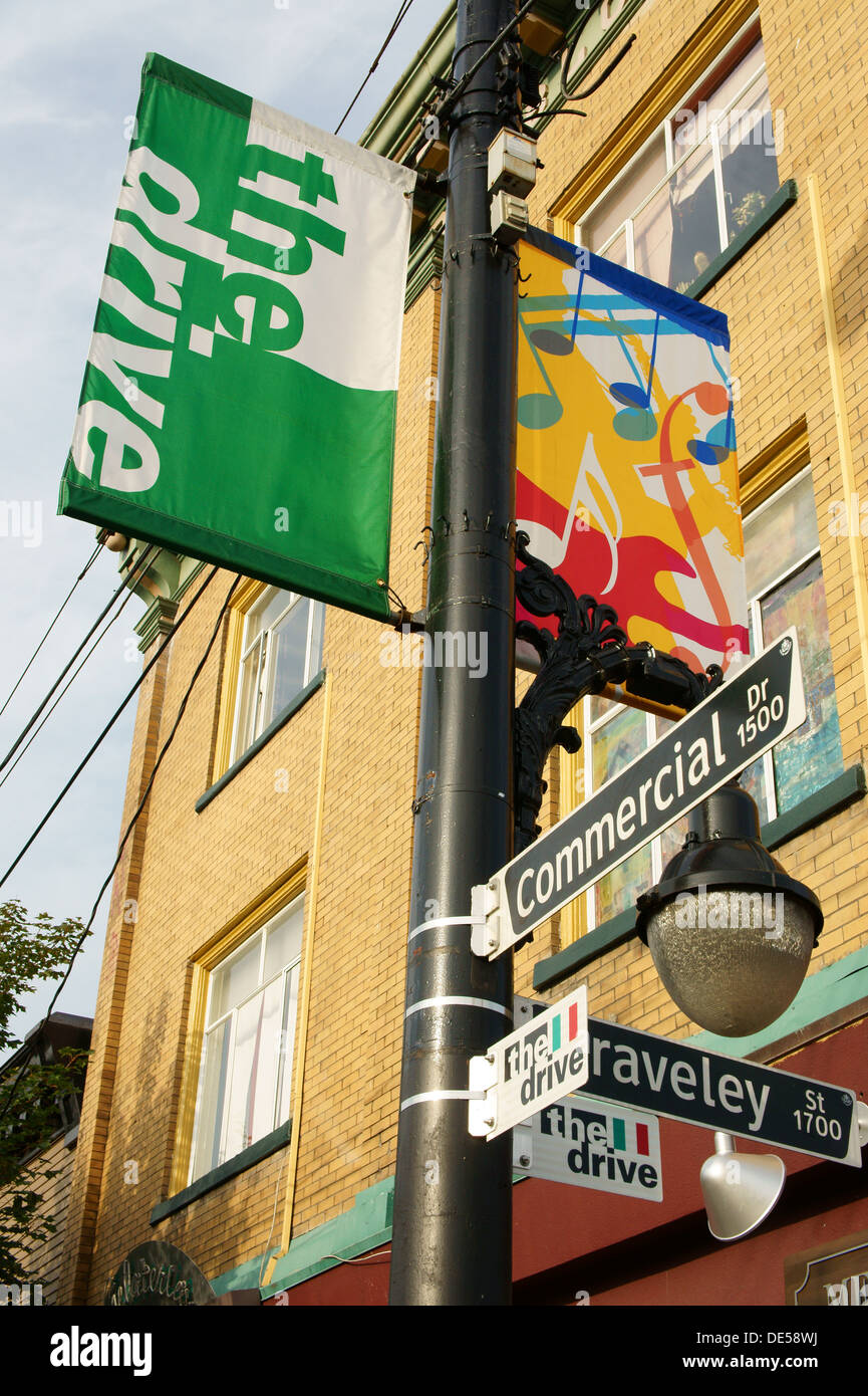 Lamppost banners and street signs on Commercial Drive, Little Italy district,Vancouver, BC, Canada Stock Photo