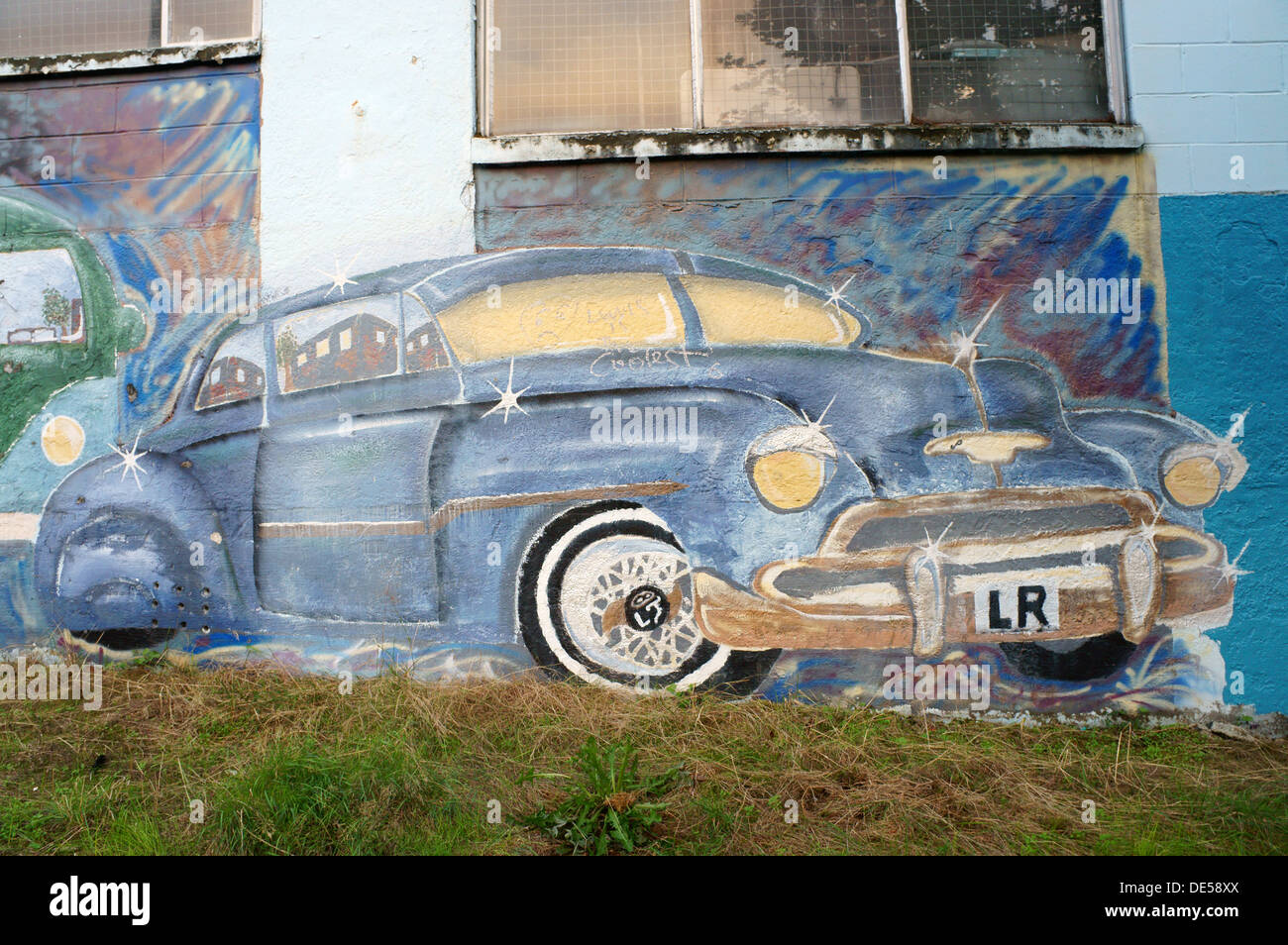 Painting of a 1940's style Chevrolet car on the wall of an automobile garage, Commercial Drive, Vancouver, Canada Stock Photo