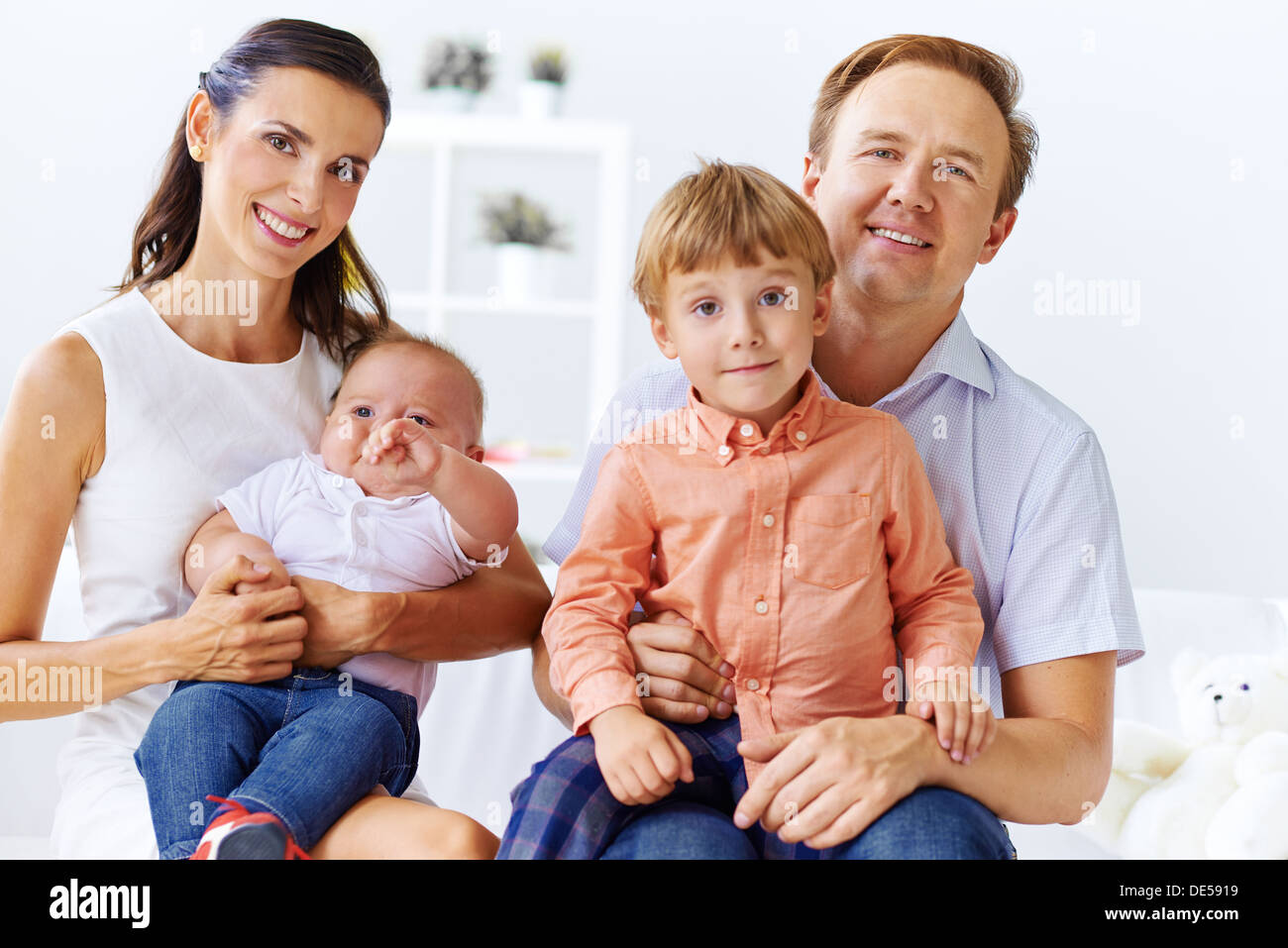 Portrait of happy family with cute sons looking at camera Stock Photo