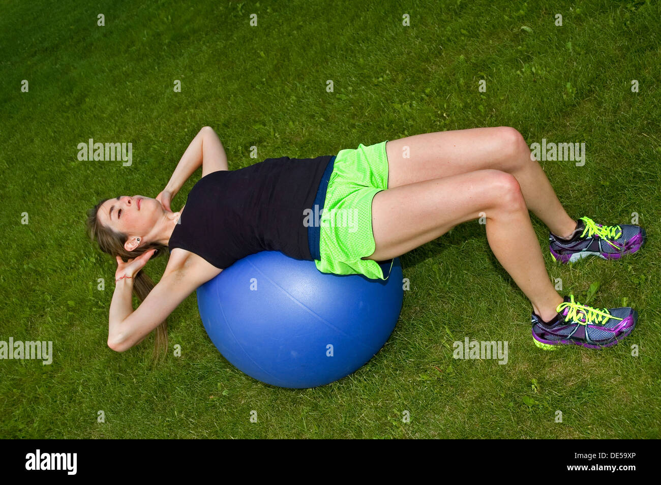 Sit ups in a park on an exercise ball Stock Photo Alamy