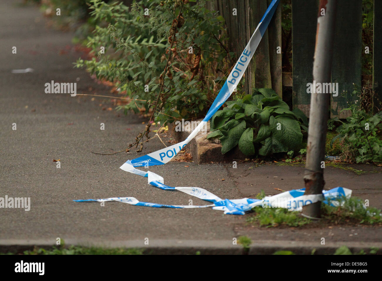 Strathclyde Police tape from a crime scene, ripped and lying on the ground.Glasgow, Scotland, UK Stock Photo