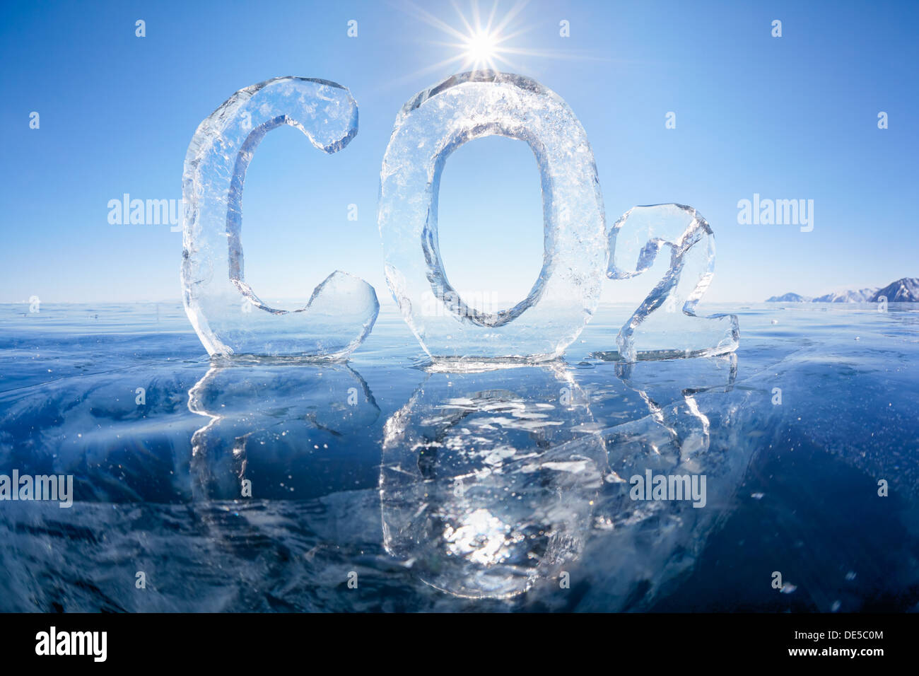 Chemical formula of greenhouse gas carbon dioxide CO2 made from ice on winter frozen lake Baikal under blue sky and Sun rays  Stock Photo