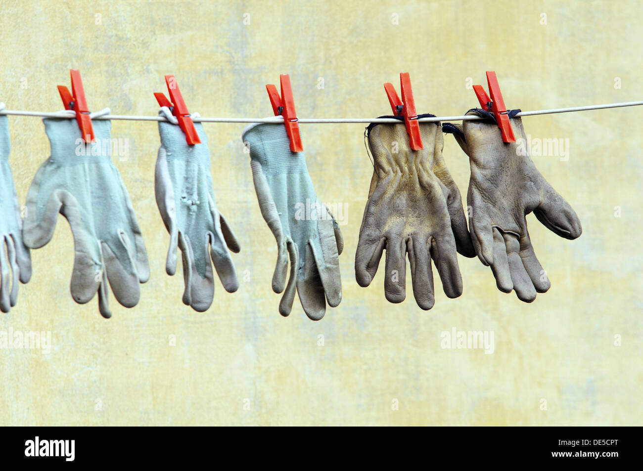 Work Gloves Hanging on a Line Stock Photo