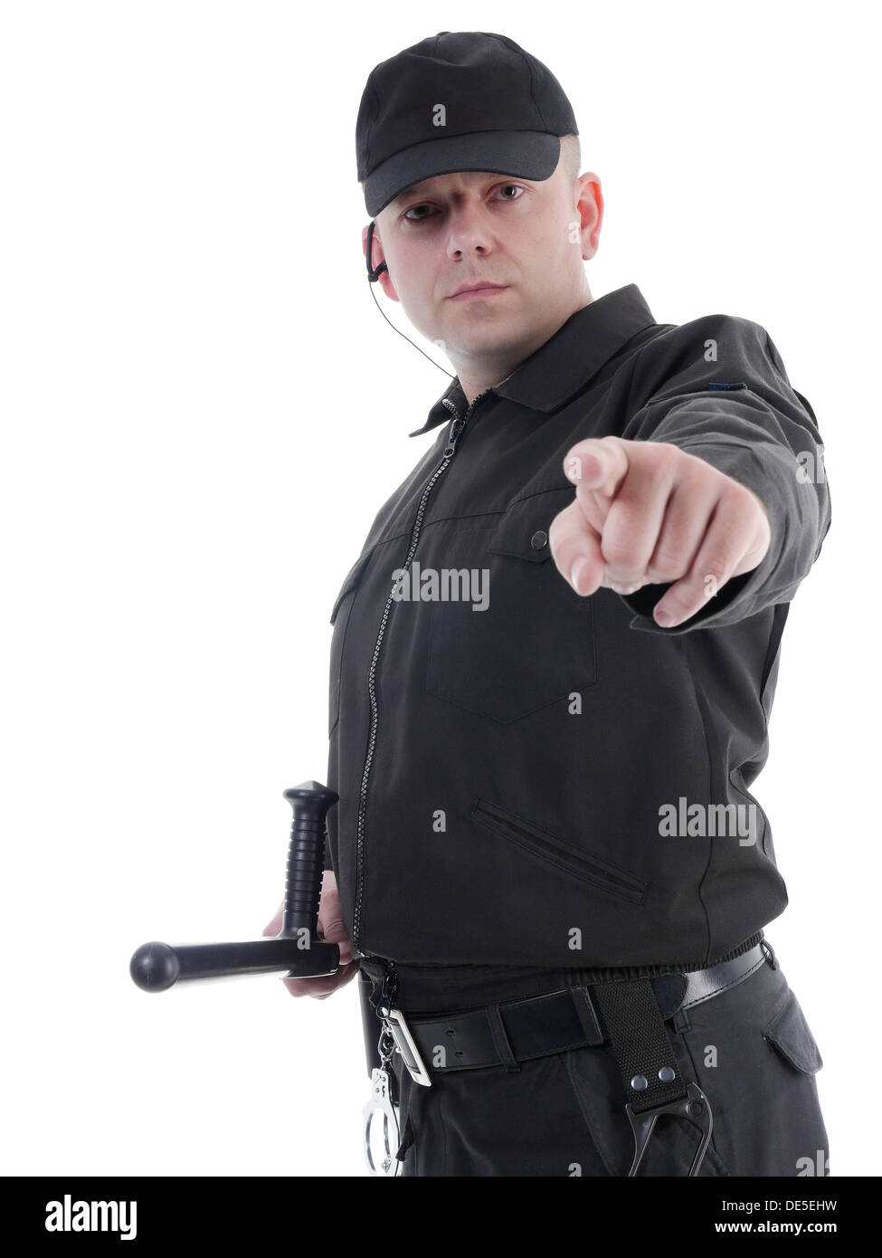 Policeman wearing black uniform pointing in ordering manner Stock Photo
