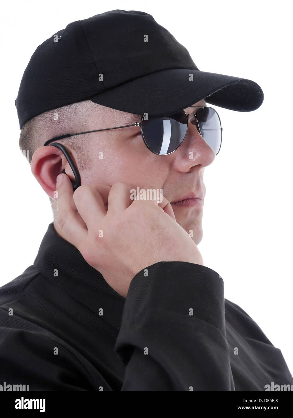 Closeup of Secret Service man using headset for communication Stock Photo