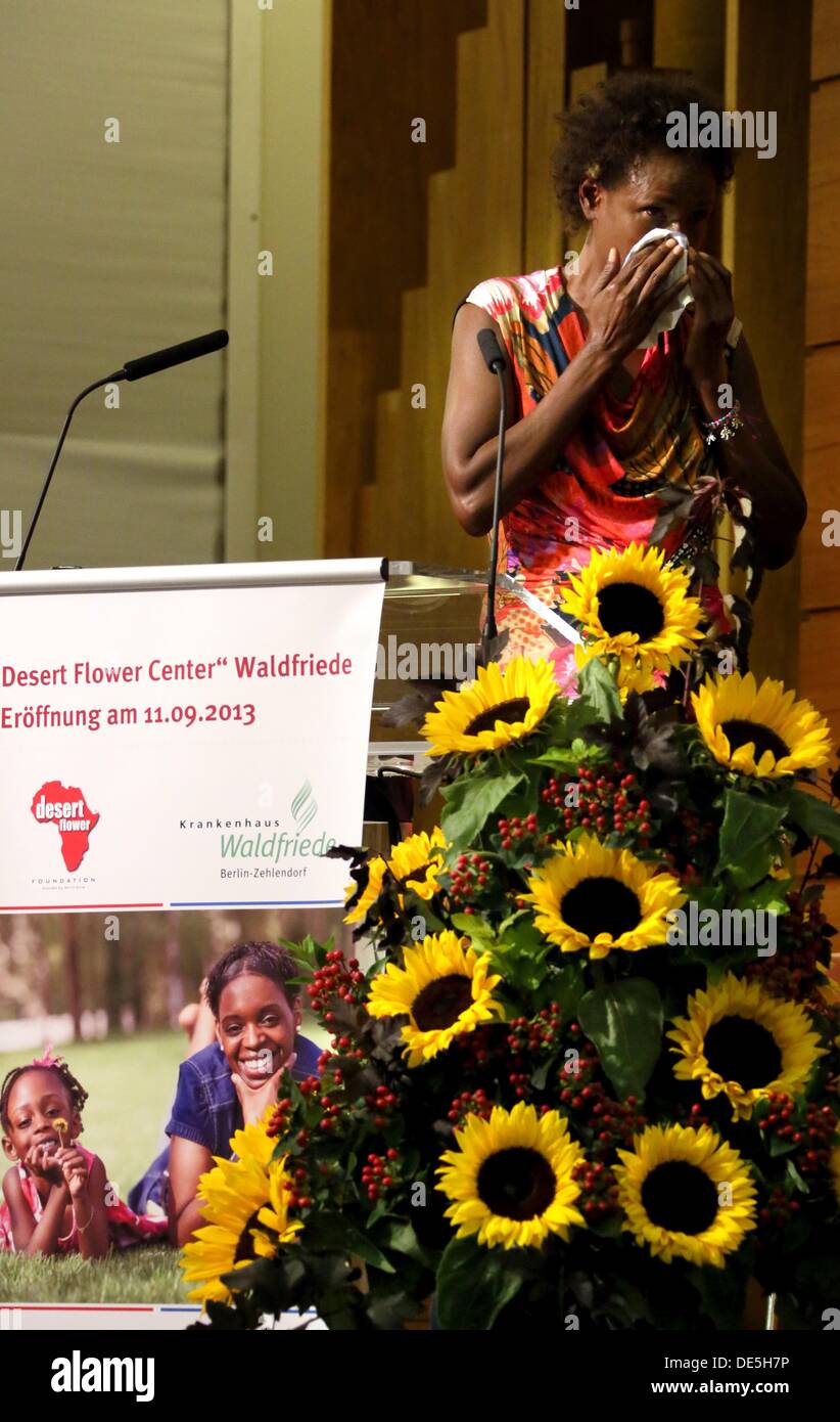Waris Dirie, Somalian author of the bestseller 'Forest Flower' and activist against female genital cutting wipes tears from her face during her speech at the opening of the 'Desert Flower Centre' of which she is a patron at hospital Waldfriede in Berlin, Germany, 11 September 2013. The centre is the first hospital in Europe that treats women with femal gentical cutting psychologically and surgically. Photo: STEPHANIE PILICK Stock Photo
