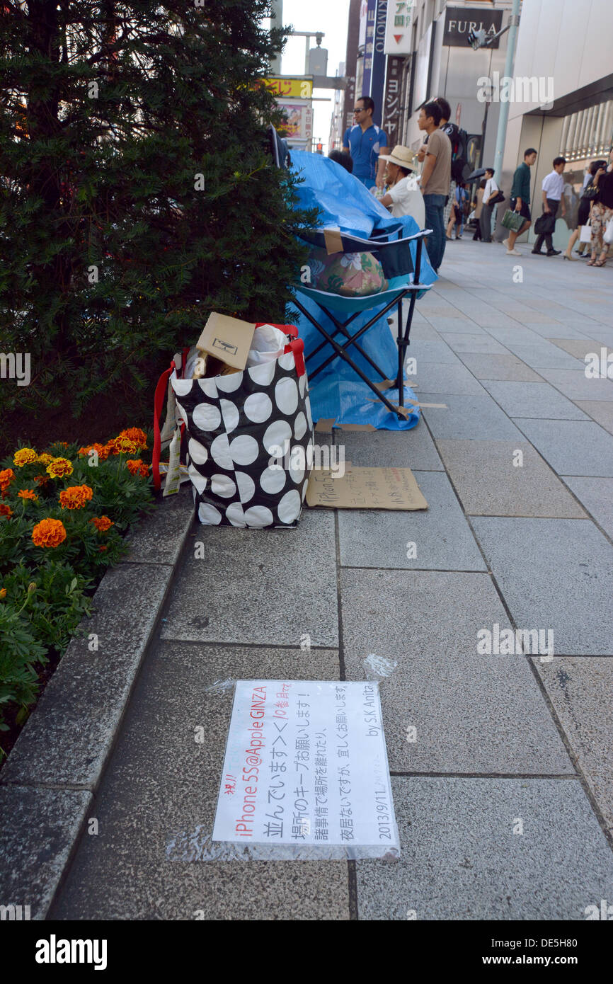 Tokyo, Japan. 12th Sep, 2013. A notice taped on the sidewalk tells "I'm the 10th in the line, I'm not here at night, but please don't steal my place!" as a small group of hard-core Apple lovers have started camping out in front of the Apple Store in Tokyo's bustling Ginza shopping district on Thursday, September 12, more than a week before the scheduled launch of iPhone 5s and lower-cost iPhone 5c. Apple announced the new mobile phones will be available in stores in Japan, U.S. and seven other countries on September 20. Credit:  Natsuki Sakai/AFLO/Alamy Live News Stock Photo