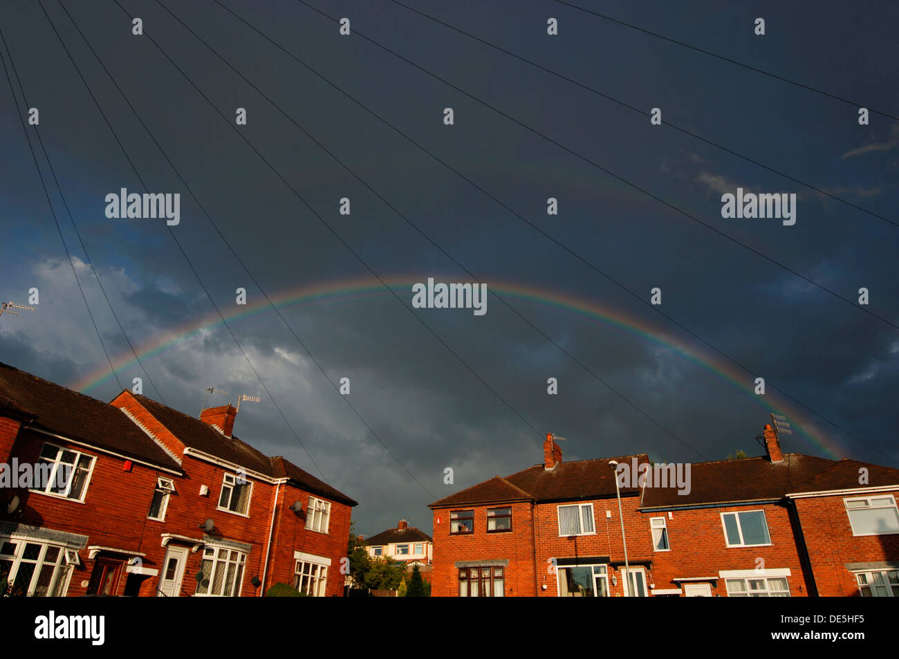 Rainbow Over Houses. Stock Photo