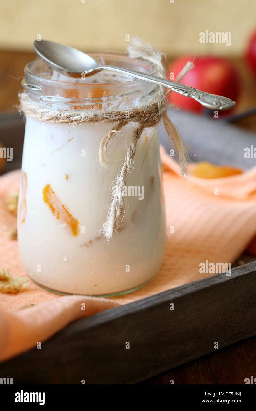 homemade yogurt with apricots in the pot, food close up Stock Photo