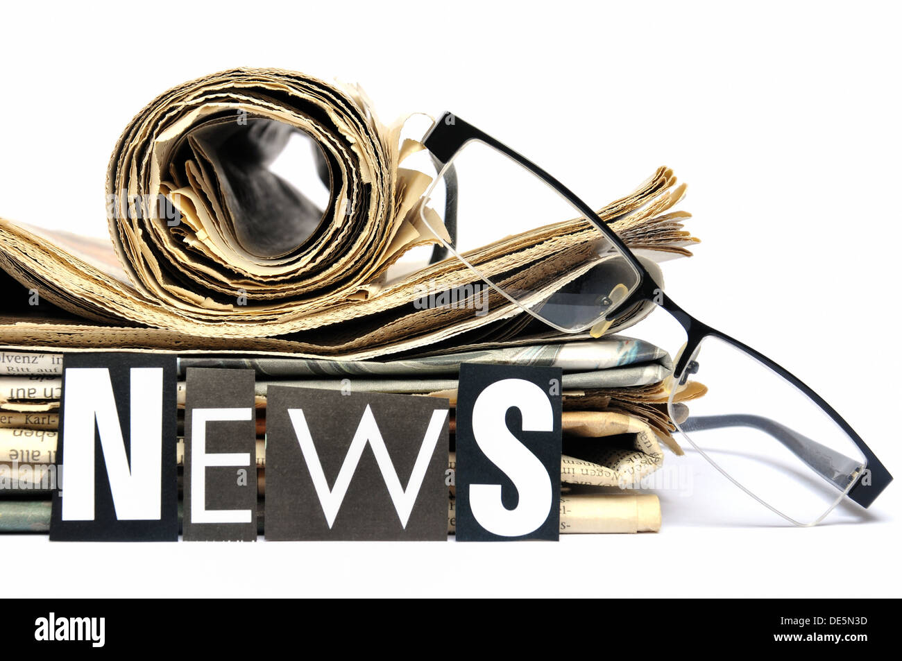 Stack of newspapers with the lettering news in front Stock Photo