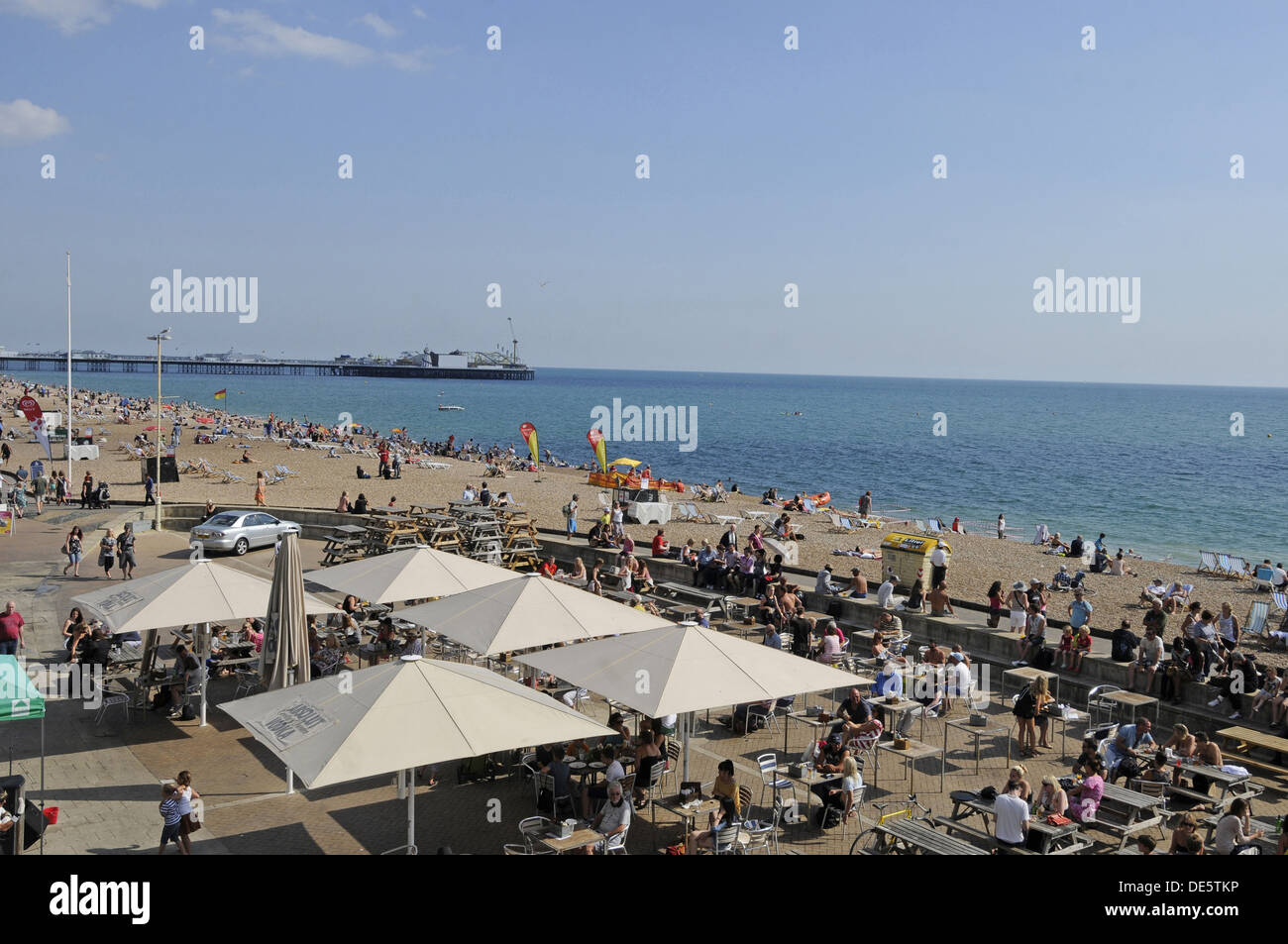 View down over beach side cafes to Brighton beach and Pier Brighton East Sussex England Stock Photo