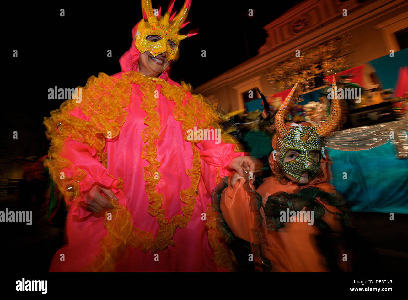 A costumed reveler called a vejigante dances in the streets during the Carnaval de Ponce February 21, 2009 in Ponce, Puerto Rico. Vejigantes are a folkloric character representing the devil. Stock Photo