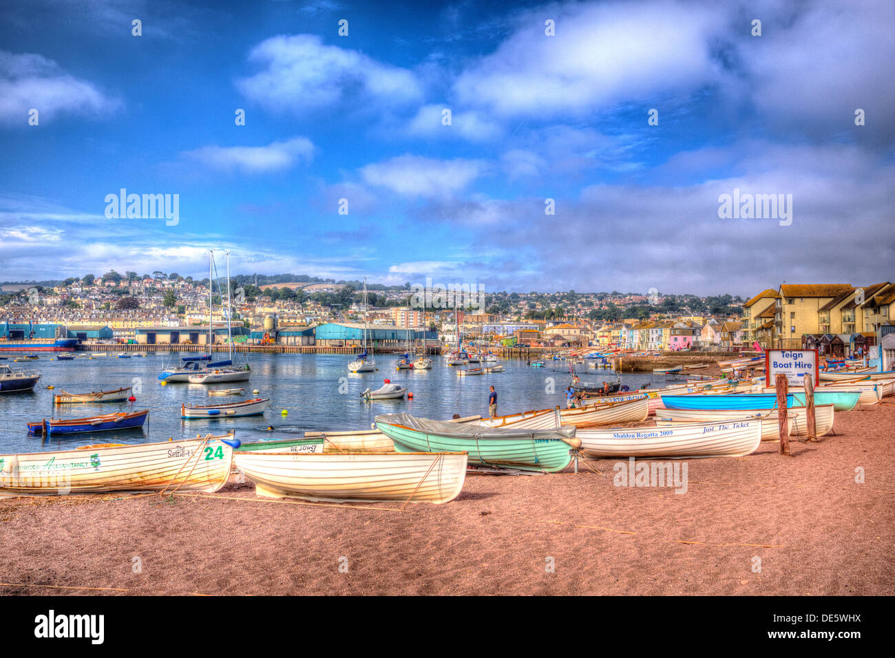 Rowing boats on sand with river and dramatic blue sky and cloudscape in HDR Stock Photo