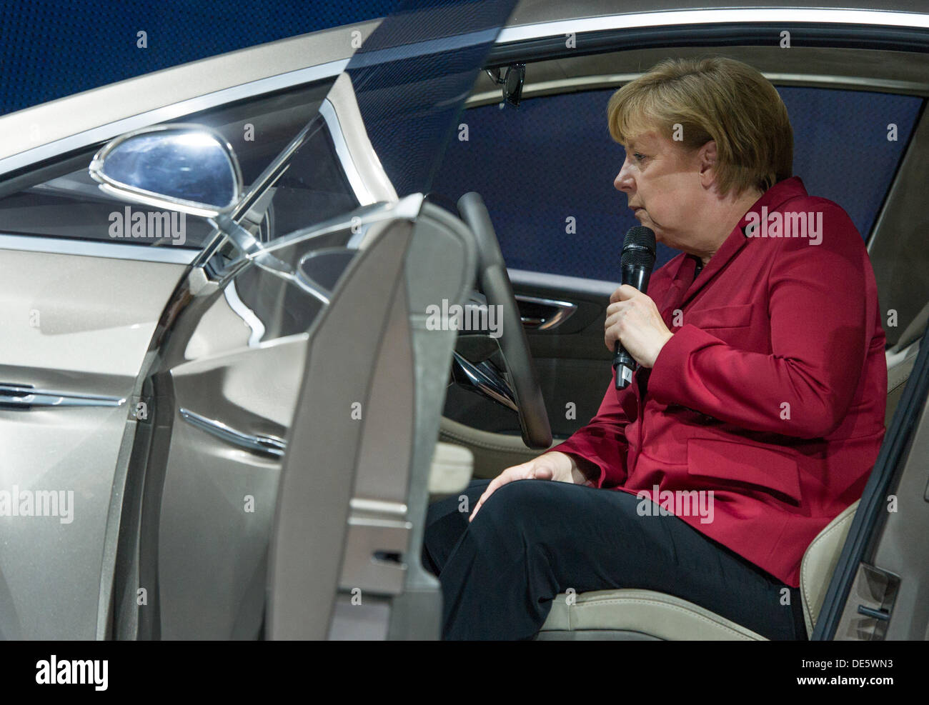 Frankfurt Main, Germany. 12th Sep, 2013. German Chancellor Angela Merkel gets into a S-Max Concept of car manufacturer Ford at the International Motor Show (IAA) in Frankfurt Main, Germany, 12 September 2013. Almost 1100 exhibitors from around the world present novelties at the world's largest automobile show IAA until 22 September 2013. Photo:UWE ANSPACH/dpa/Alamy Live News Stock Photo