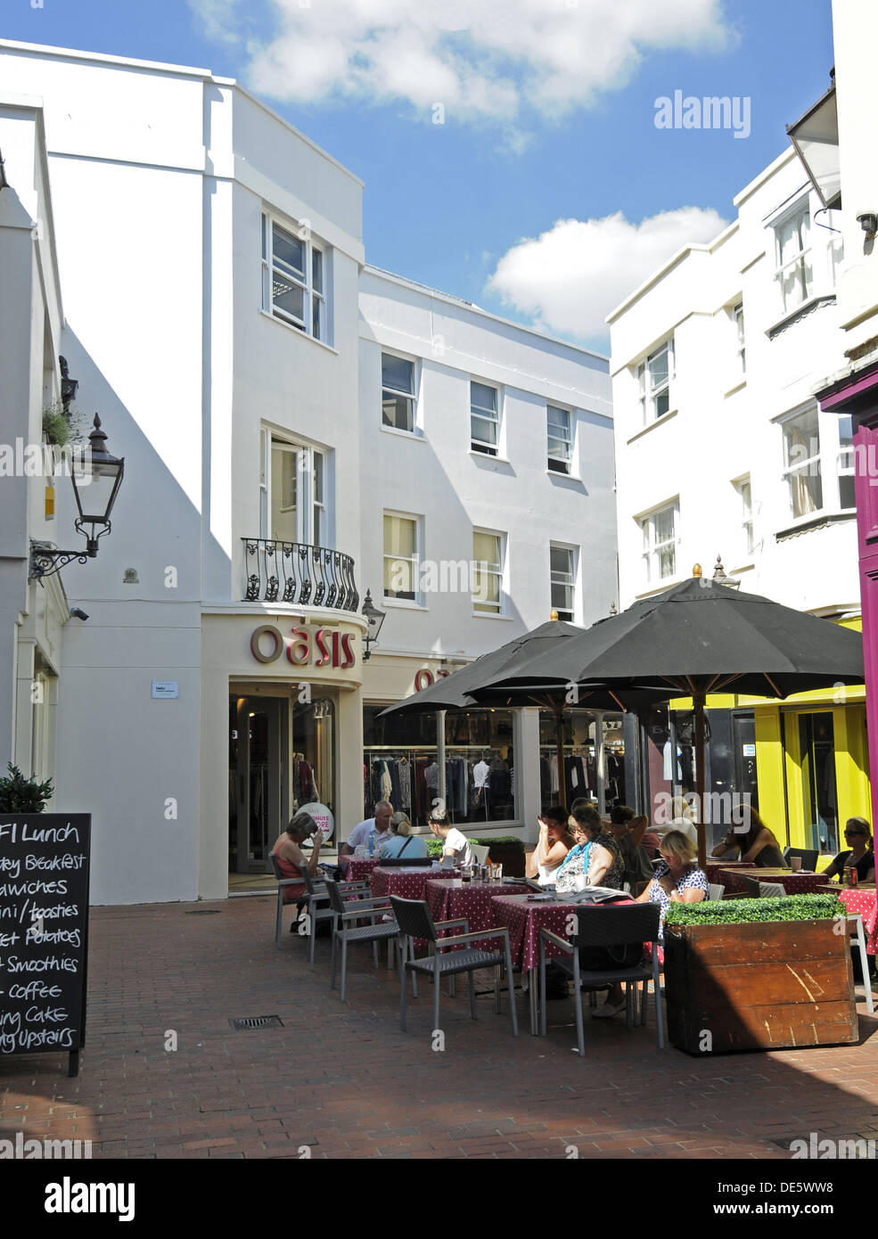 Shops and Cafe with people eating Al Fresco in Dukes Lane Brighton East Sussex England Stock Photo