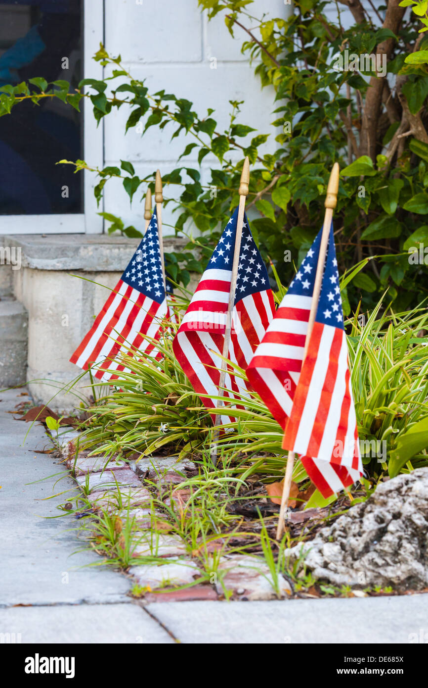 American flags along sidewalk in front of house in Cedar Key, Florida Stock Photo