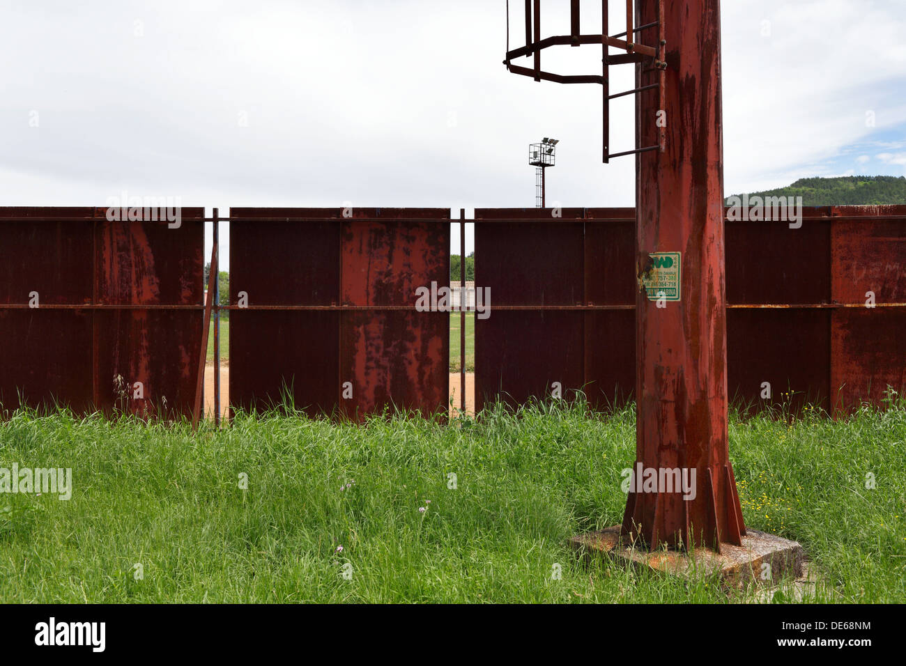 Zelena, Croatia, rusted pillars and fence at a sports stadium Stock Photo