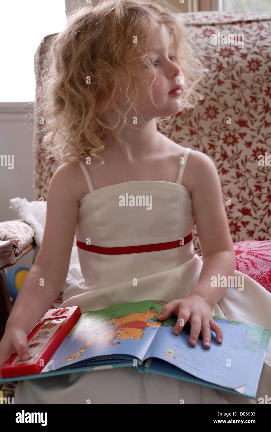 A little girl reading a book with sound effects Stock Photo Alamy