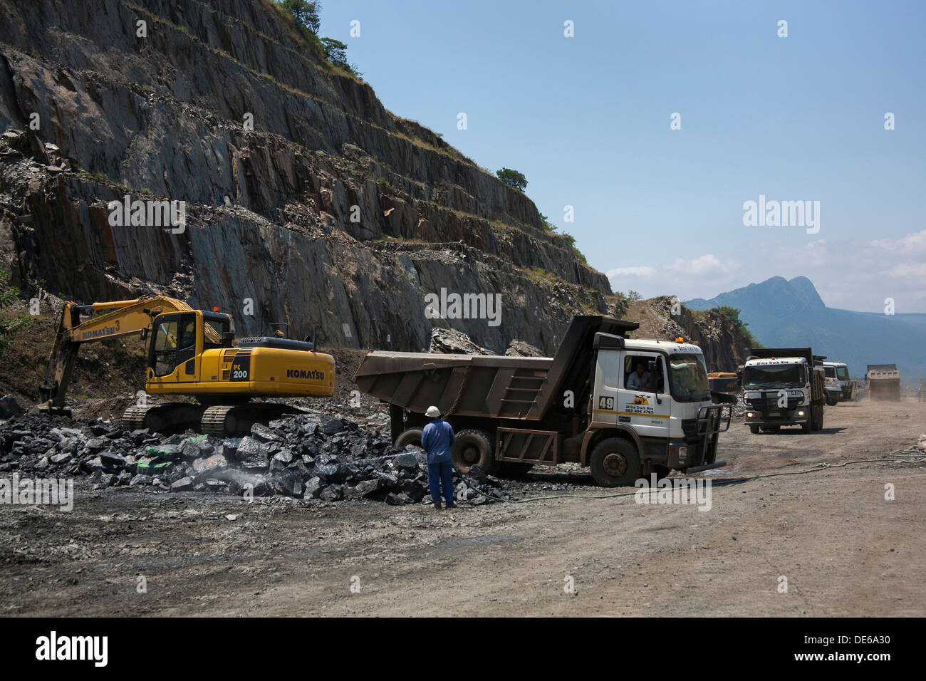 Gold ore being loaded onto trucks for transport to a processing plant Stock Photo