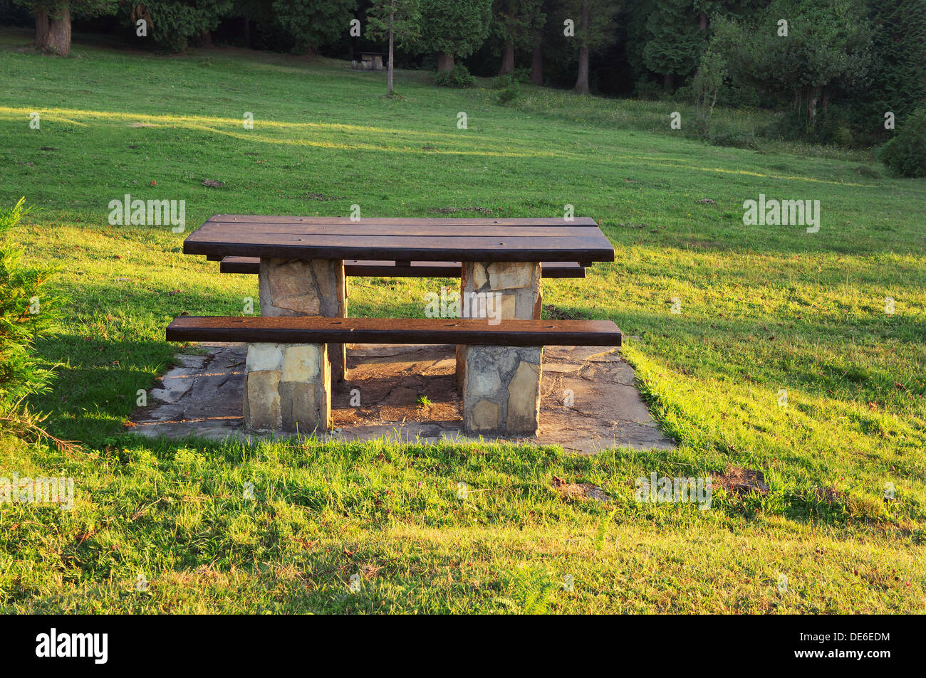 picnic table on countryside with sun rays Stock Photo