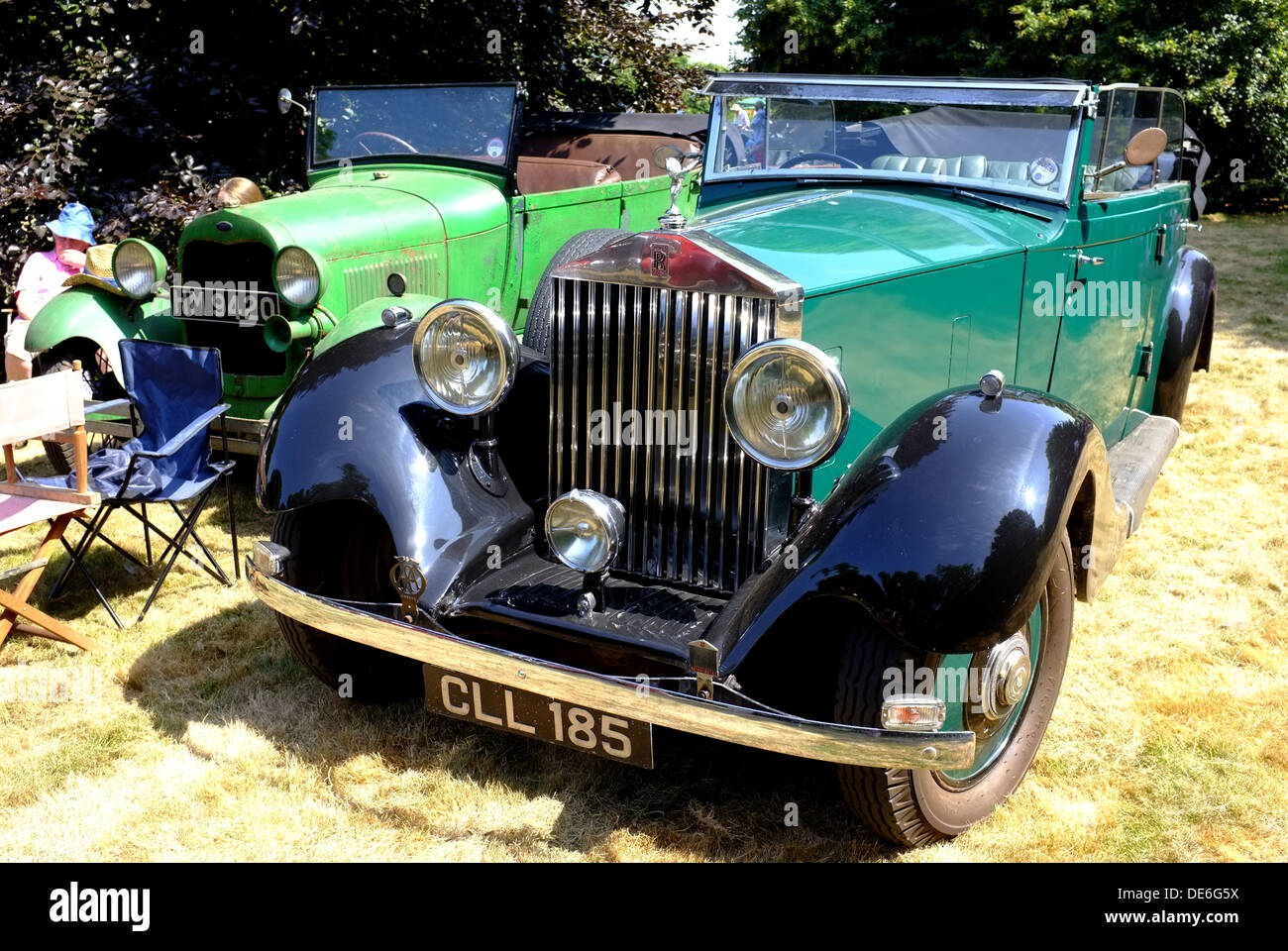 Perfect Rolls Royce and ratty Ford Model A classic cars parked together at a picnic Stock Photo