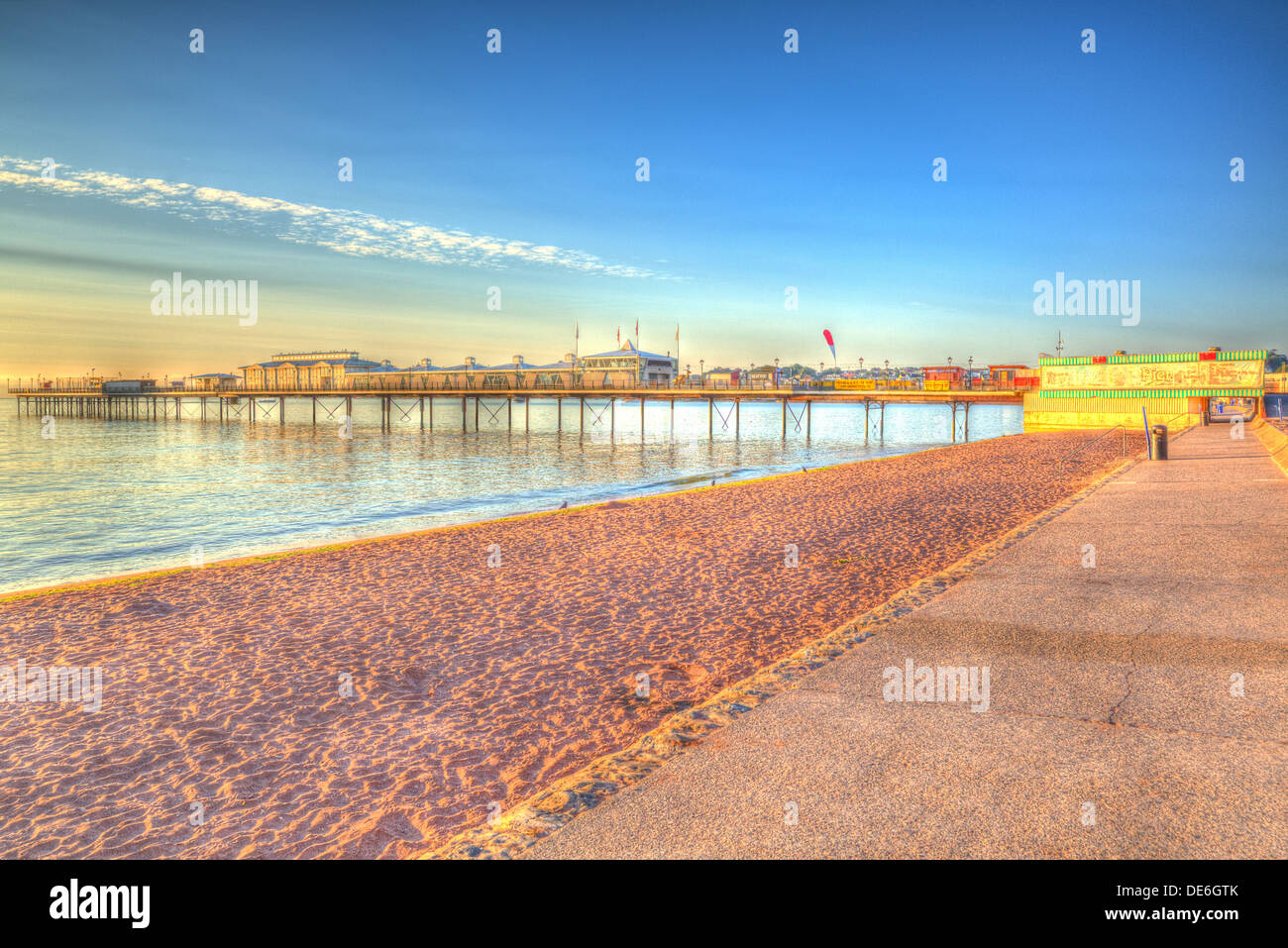 Paignton pier and sandy beach Torbay Devon England in HDR with blue sky, near tourist destinations of Torquay and Brixham Stock Photo
