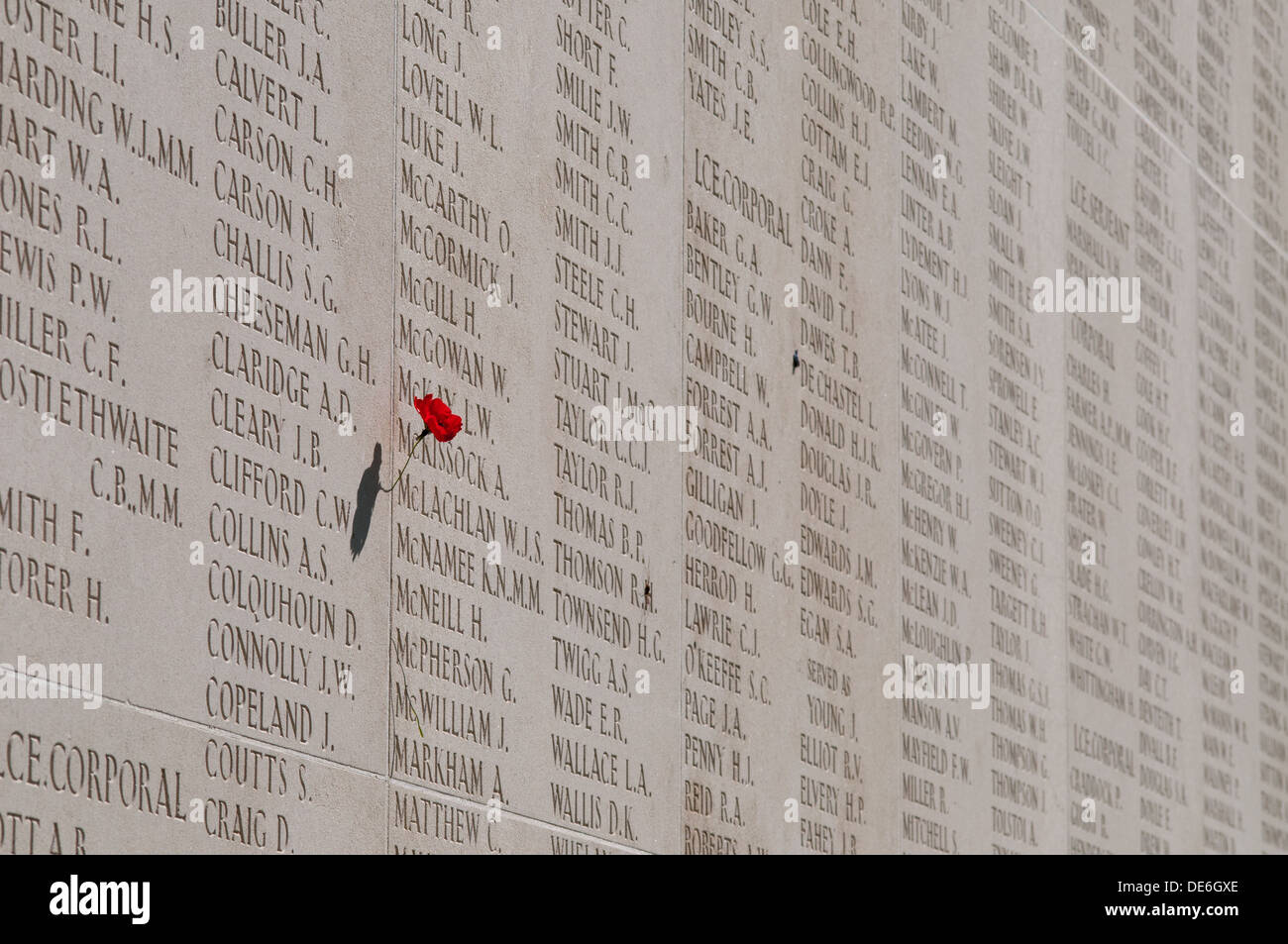 Poppy attached to name on wall engraved with names of the missing, Australian National War Memorial, Villers-Bretonneux, Somme Stock Photo