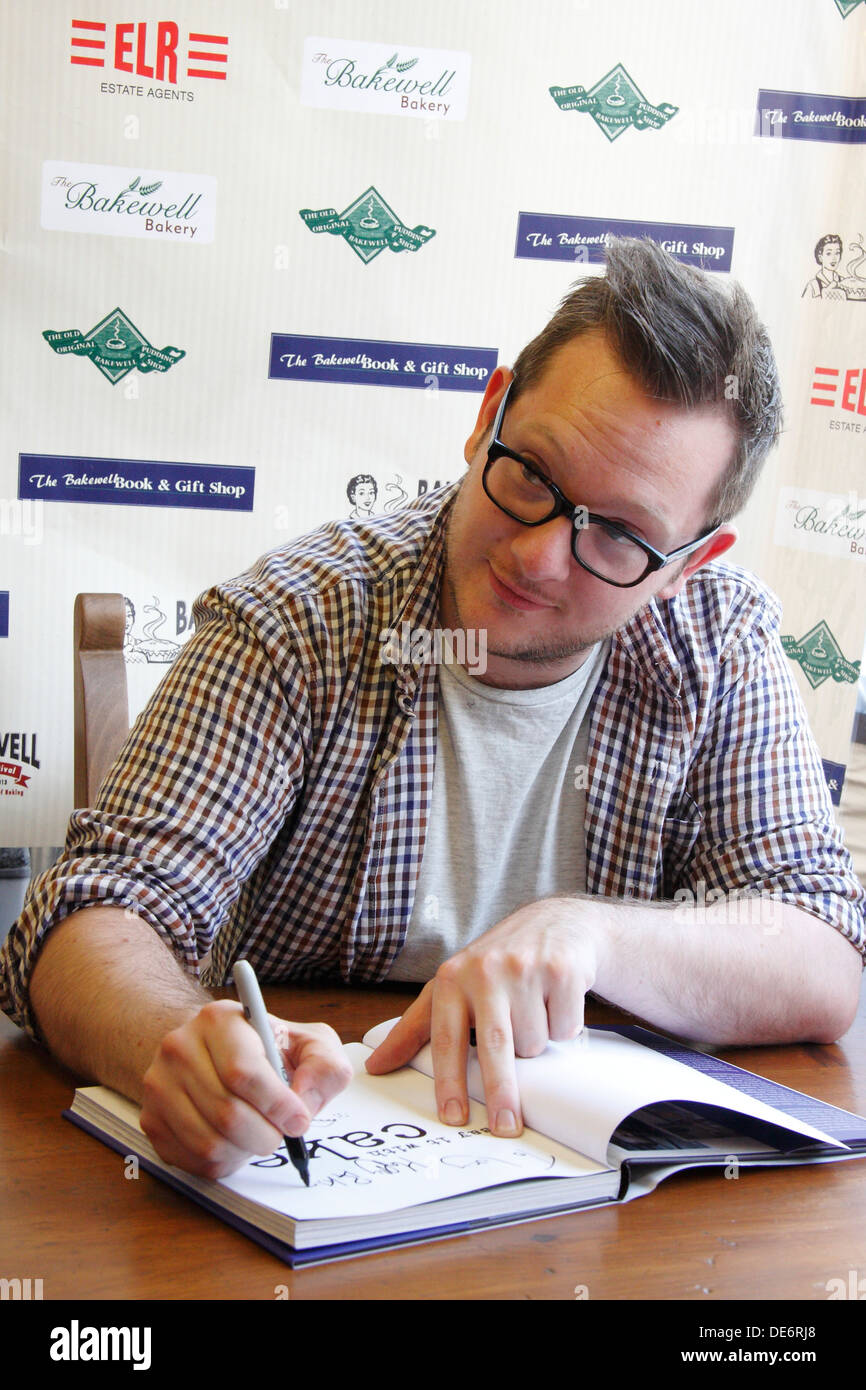 BBC Great British Bake Off winner 2010, Edd Kimber signs his book 'Say it with Cake' at Bakewell Baking Festival, England, UK Stock Photo