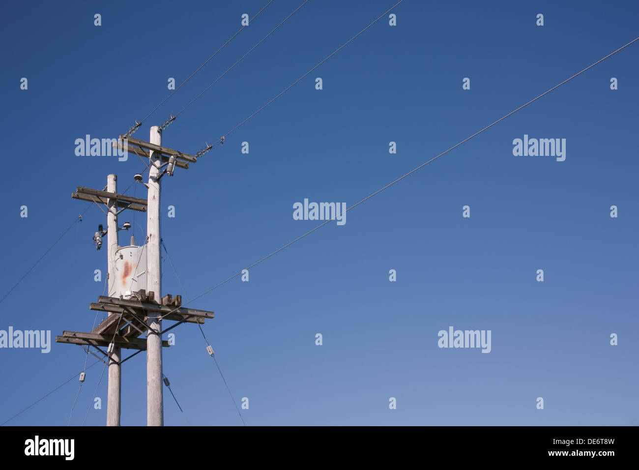 Power pole with transformer and clear blue sky Stock Photo