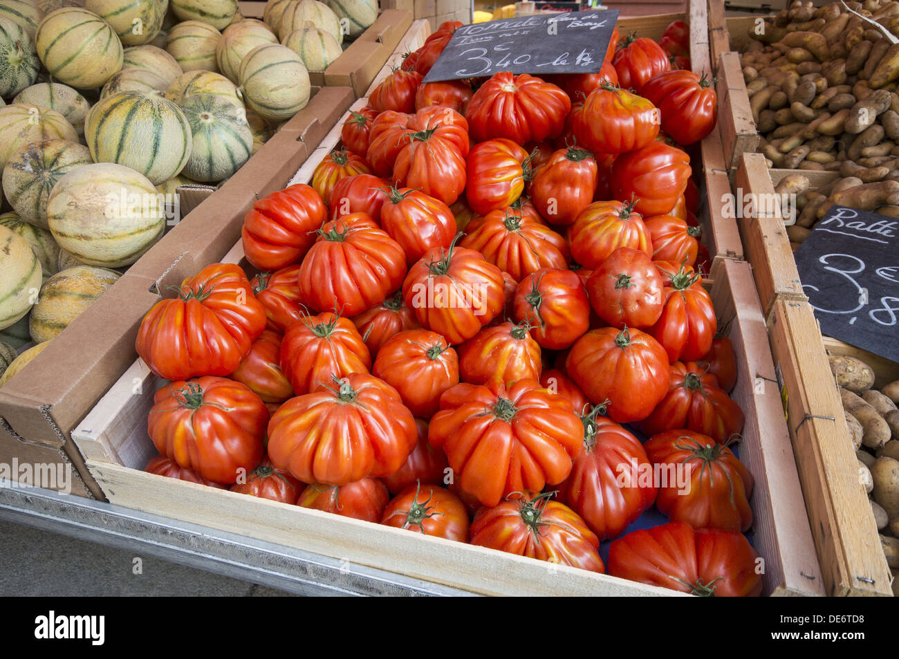Grandmas pick tomatoes on sale at the sunday market on the streets of Le Puy-en-Velay in Auvergne region of France Stock Photo