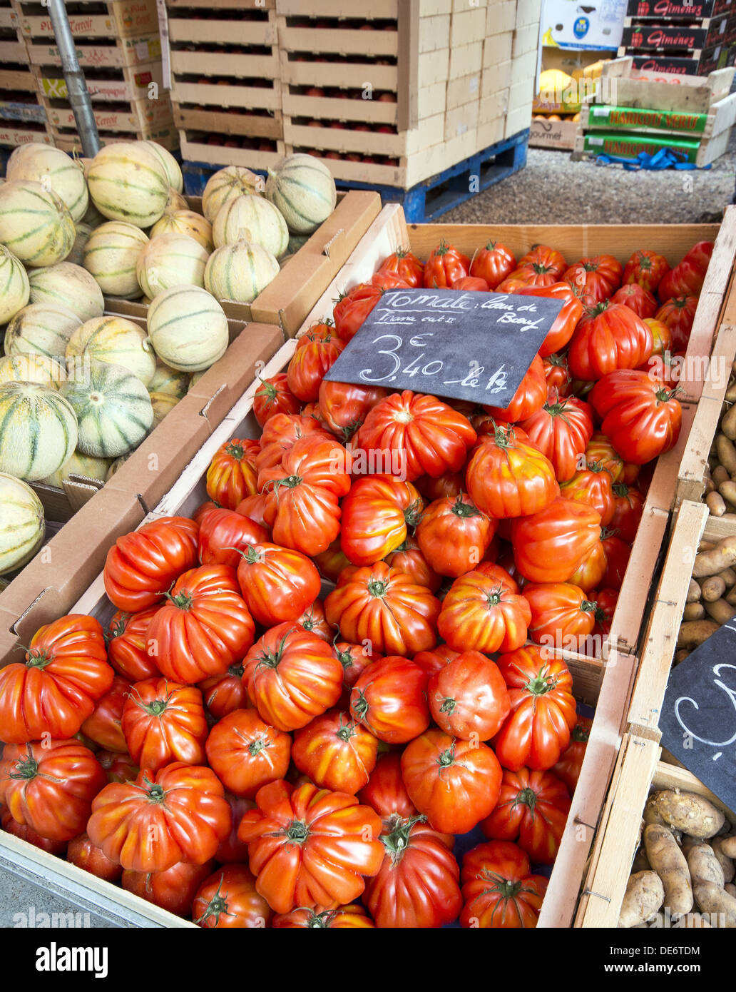 Grandmas pick tomatos on sale at the sunday market on the streets of Le Puy-en-Velay in Auvergne region of France Stock Photo