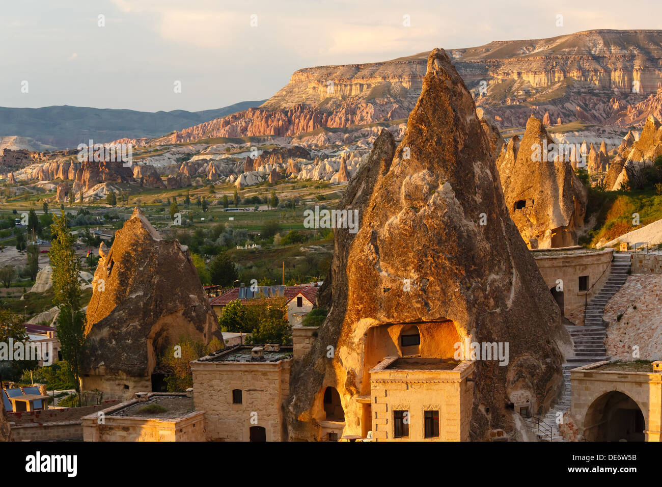 Hotel rooms cut down in the rock in the light of the setting sun. Cappadocia, Turkey Stock Photo