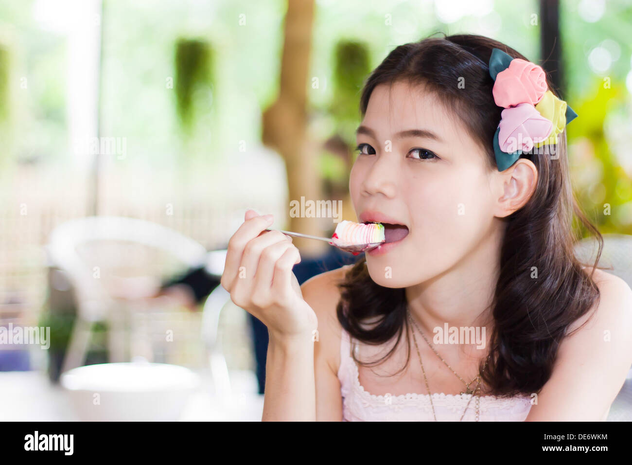 Portrait thai girl eating a spoon of cake Stock Photo