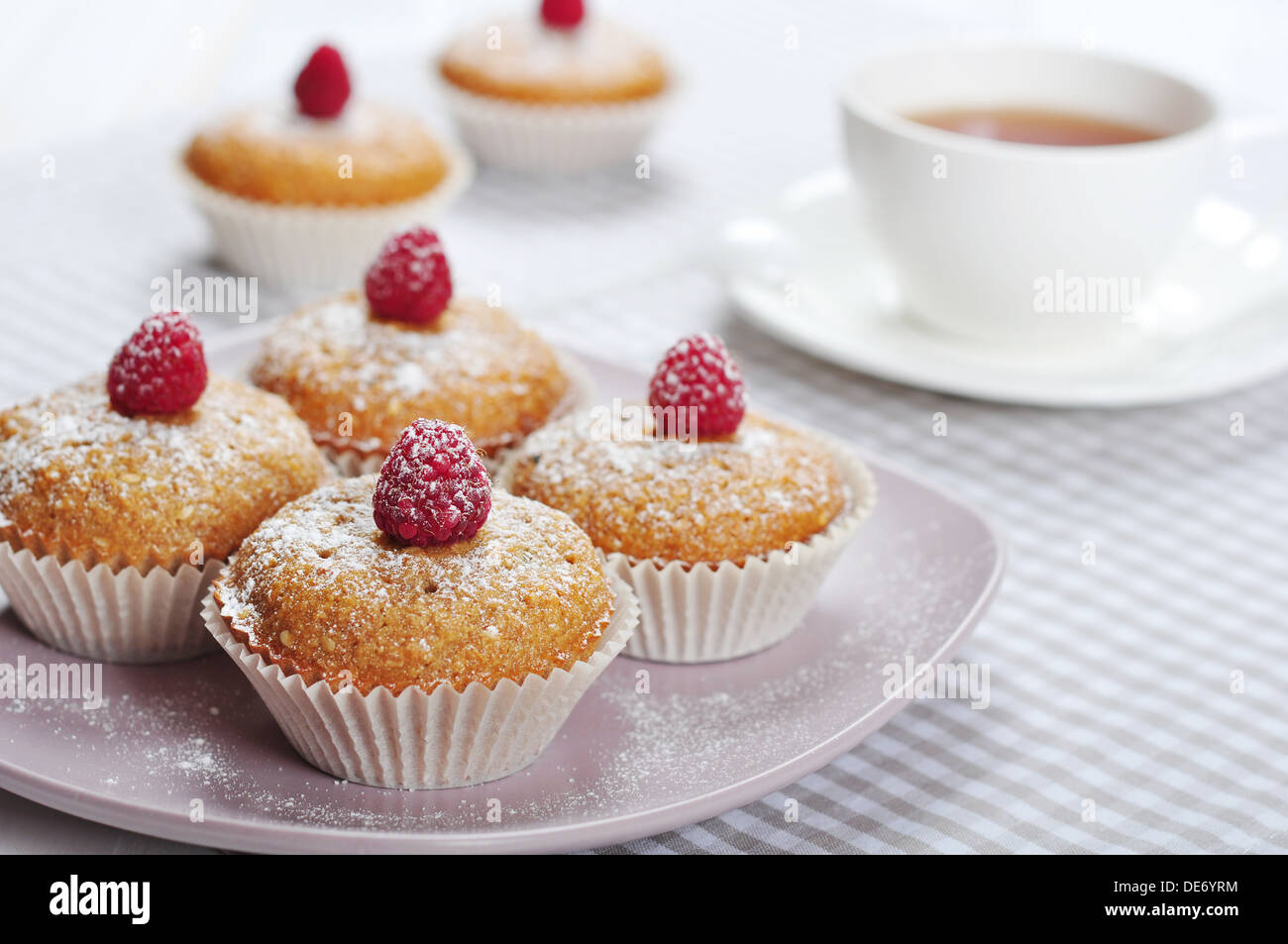 Diet muffins with bran and fresh raspberries on plate Stock Photo