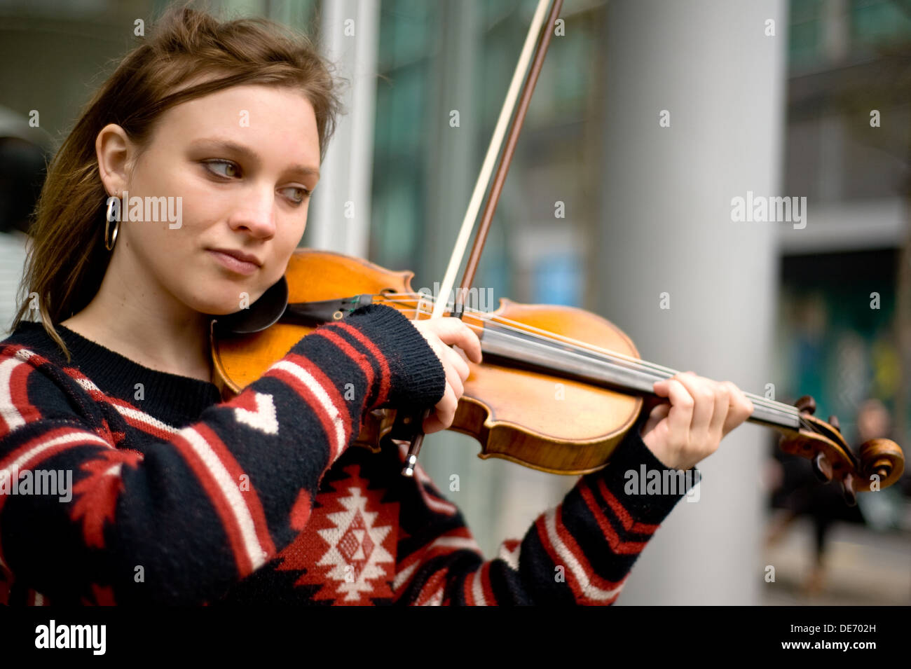 A female street musician playing the violin Stock Photo