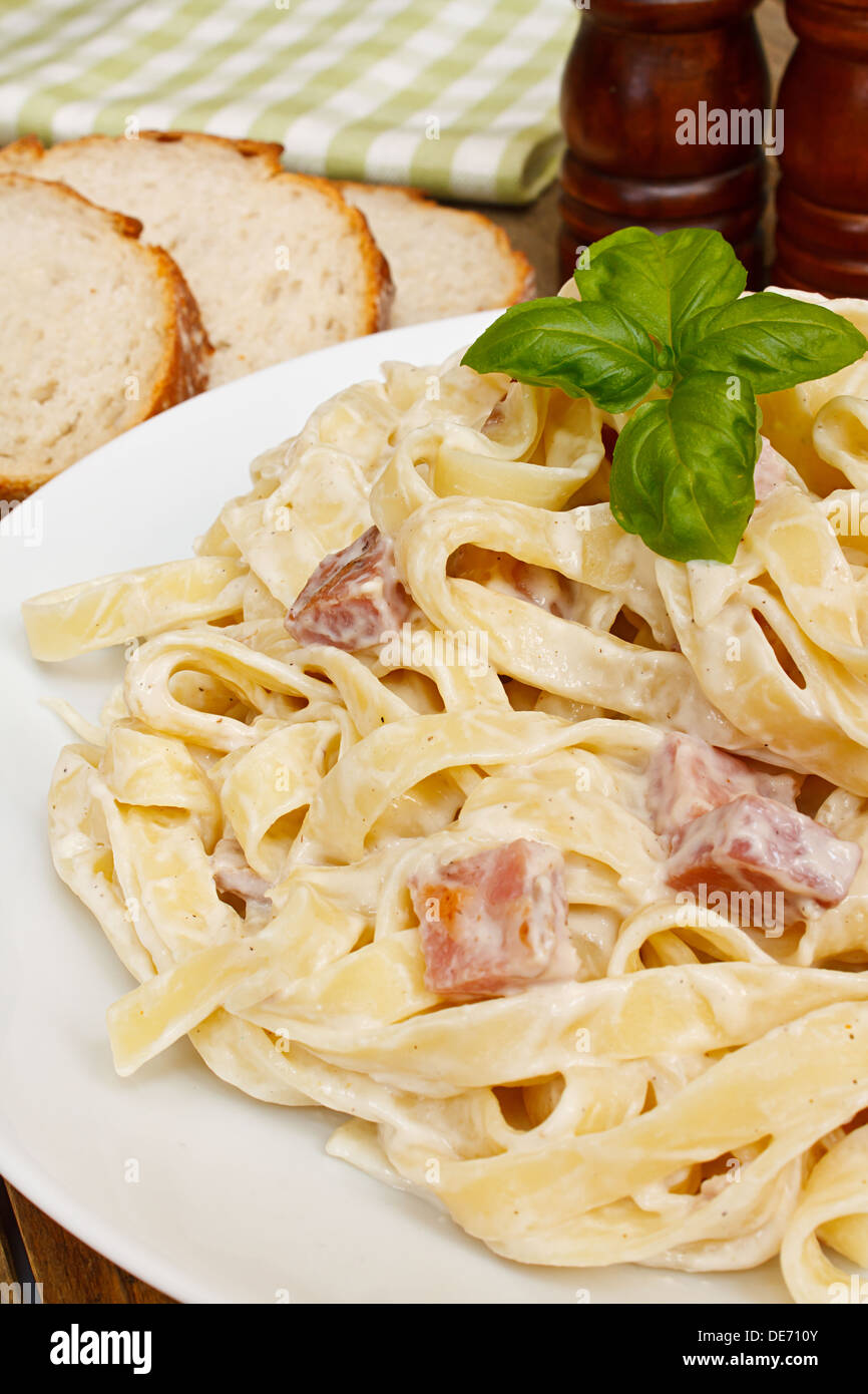 close up of a plate of tagliatelli carbanara italian cuisine in a traditional restaurant setting Stock Photo