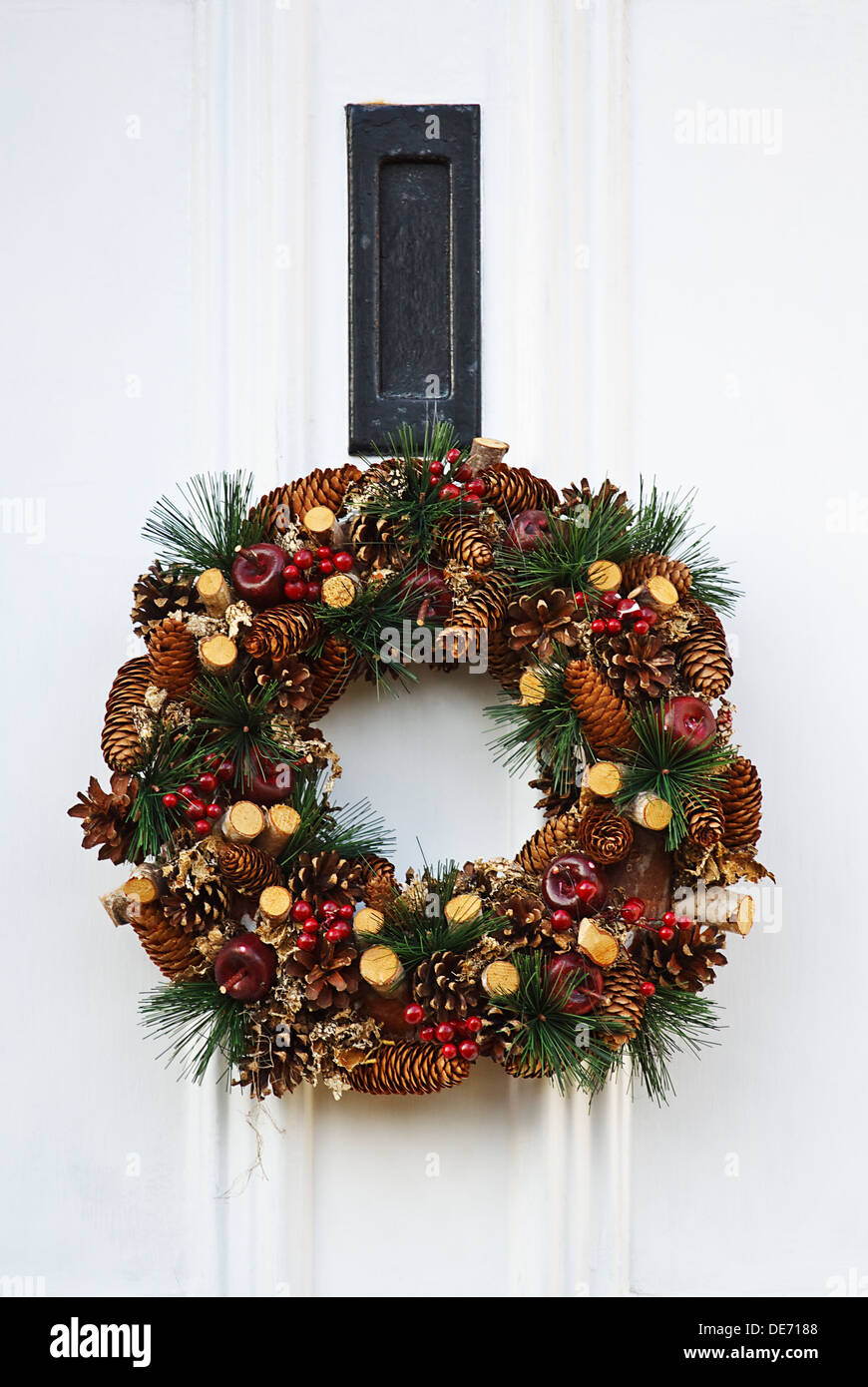 Festive Christmas wreath on white door at xmas Stock Photo