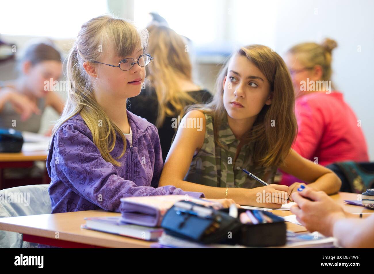 13 year old Fenja (L) with Down's syndrome sits with other pupils during class in the eighth grade as Marienschule secondary school in Hildesheim, Germany, 06 September 2013. Photo: SEBASTIAN KAHNERT Stock Photo