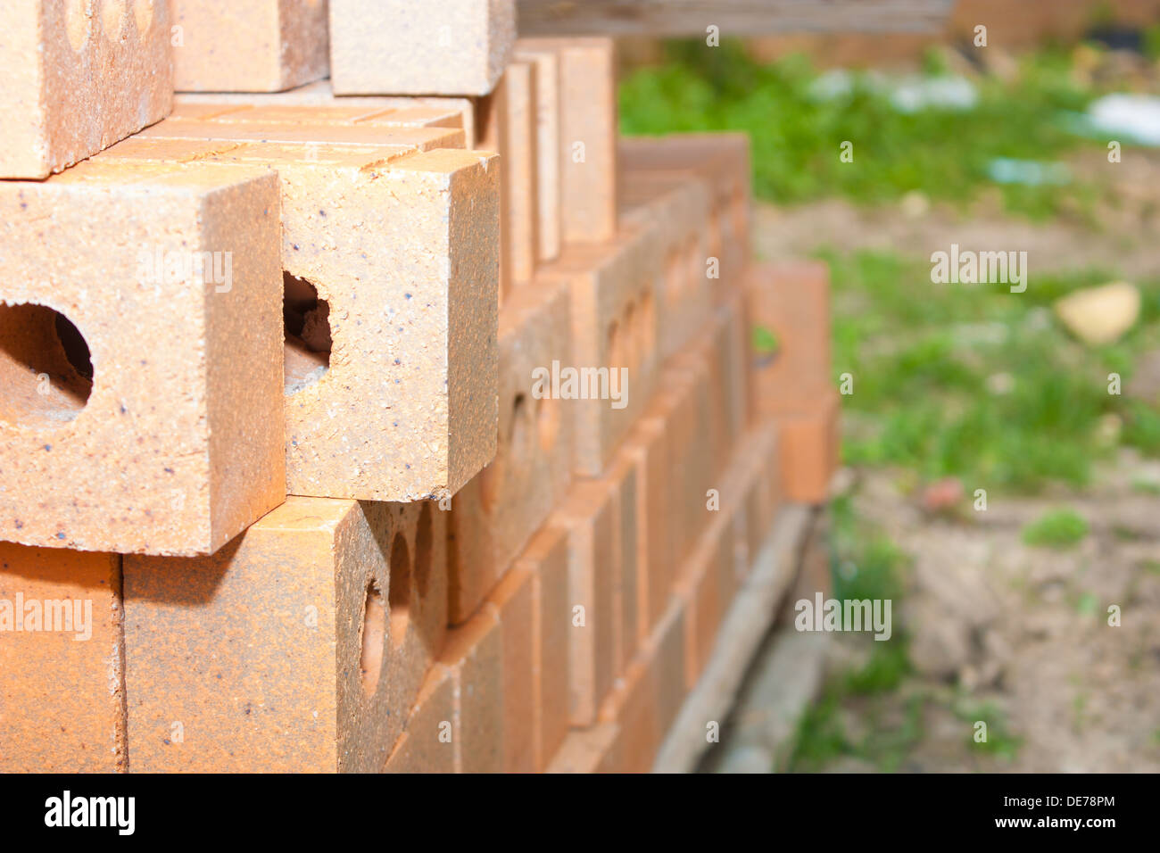 A pile of bricks sits on a skid at a school construction site waiting ...