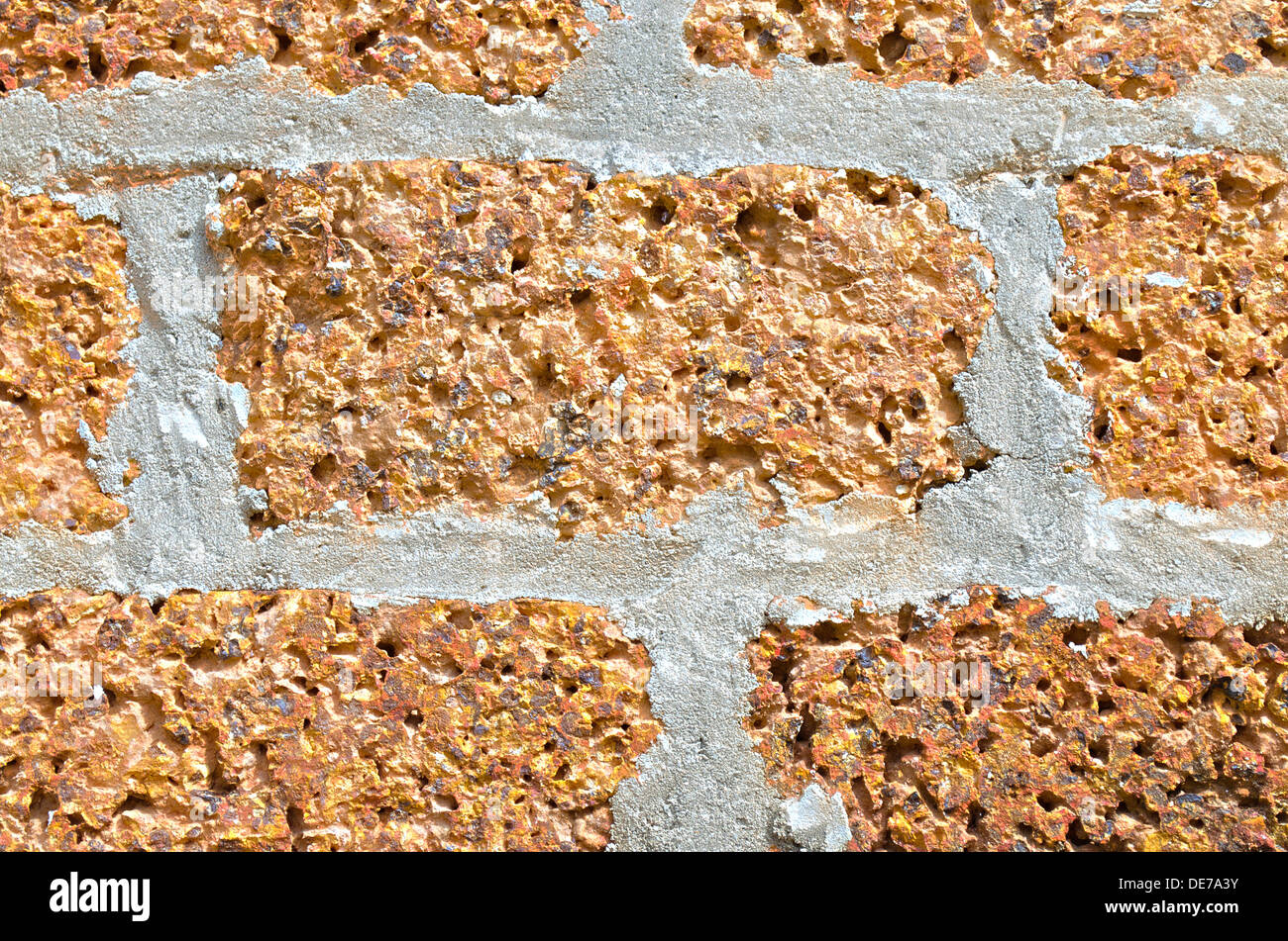 The Wall made of Laterite Stone and cement. Stock Photo