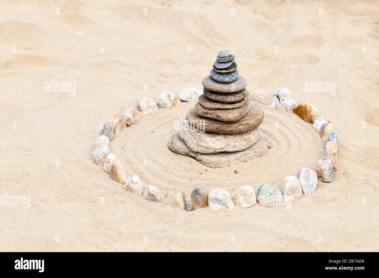 Zen stones pyramid on sand Stock Photo