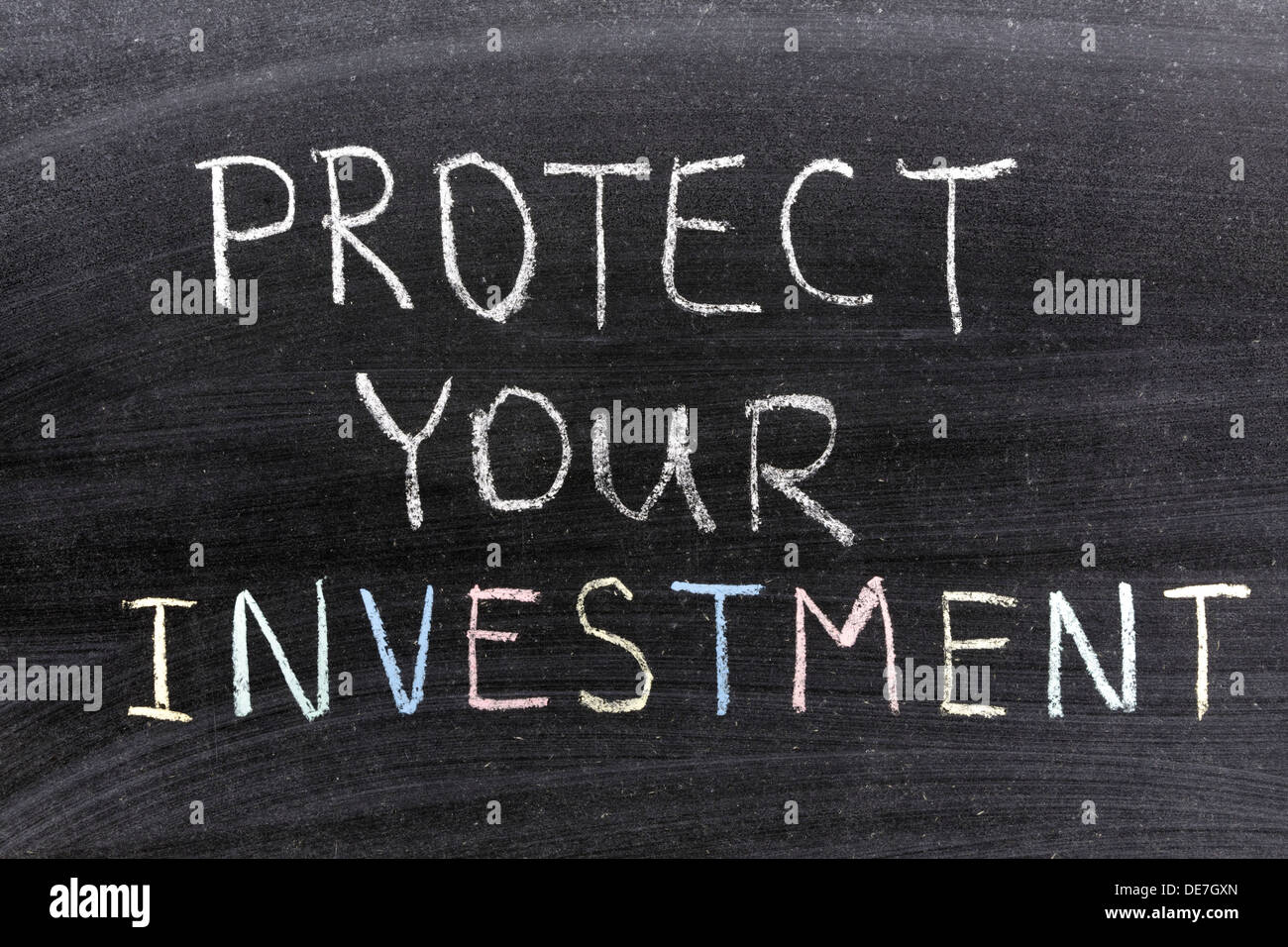 protect your investment phrase handwritten on the school blackboard Stock Photo