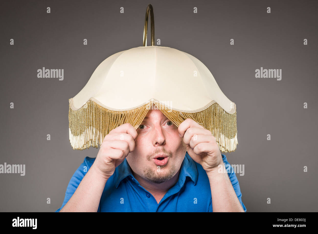 Portrait of mid adult man with electric lamp, close up Stock Photo