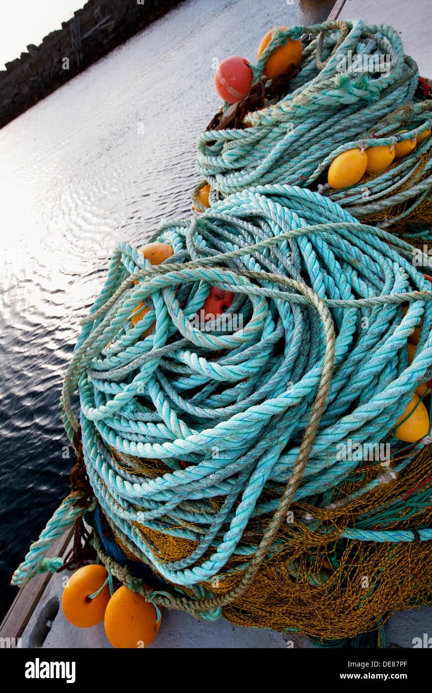 Ropes, fishing nets and floats on the quay in the harbour of Stø
