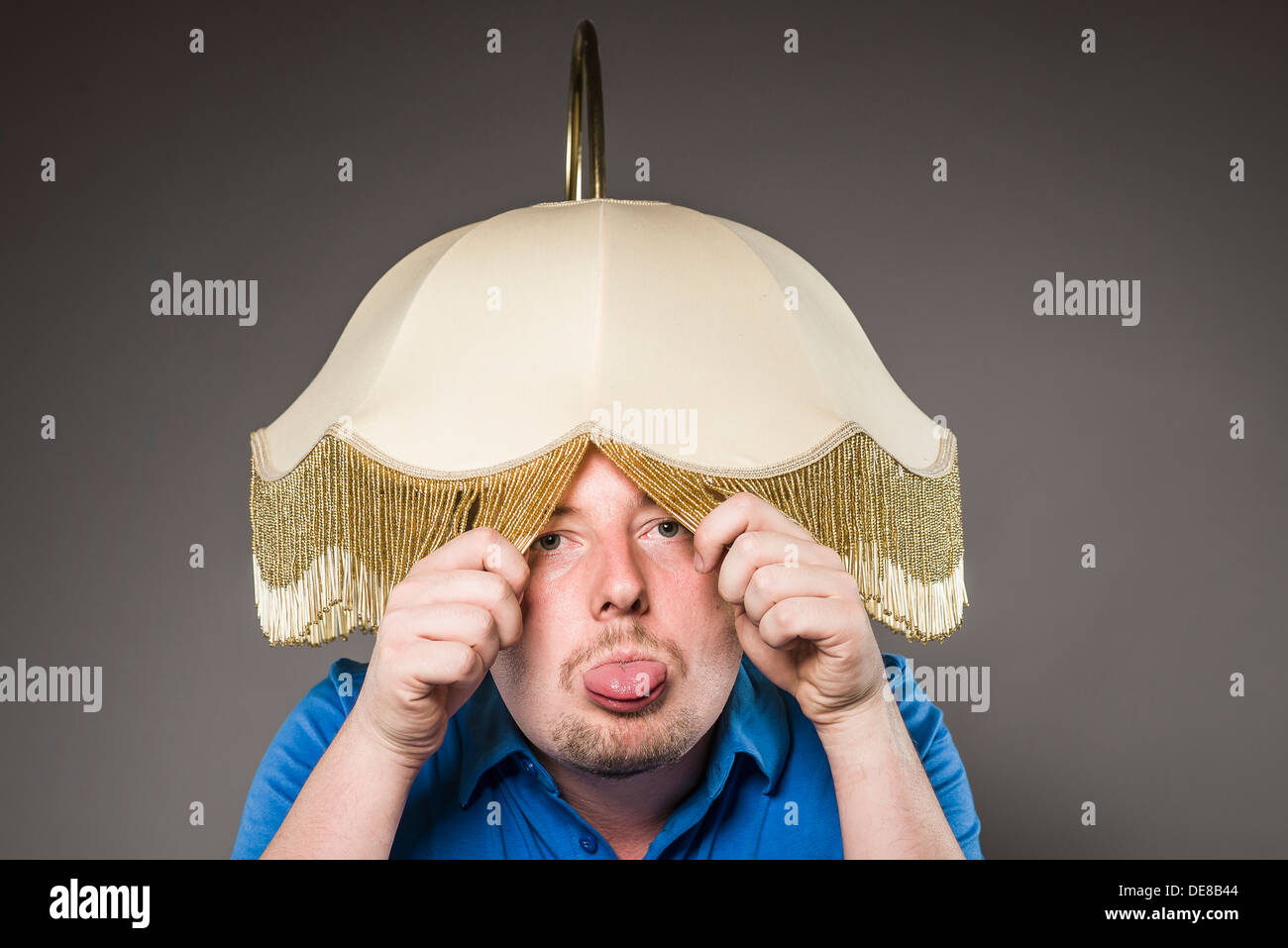 Portrait of mid adult man with electric lamp, close up Stock Photo