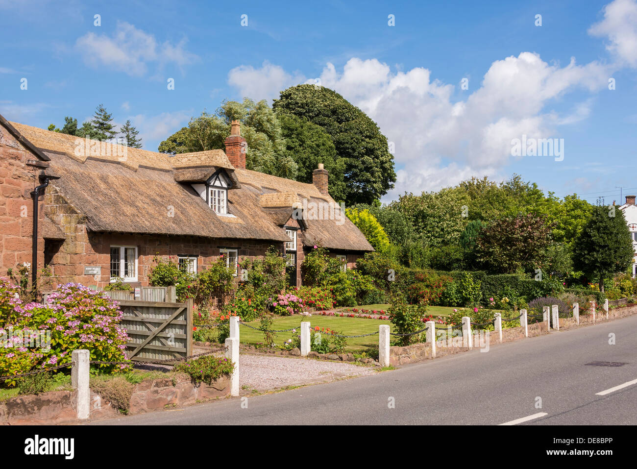 Burton a village on the Wirral Peninsula. Thatched cottage. House name is Bishop Wilson's Cottage. Stock Photo