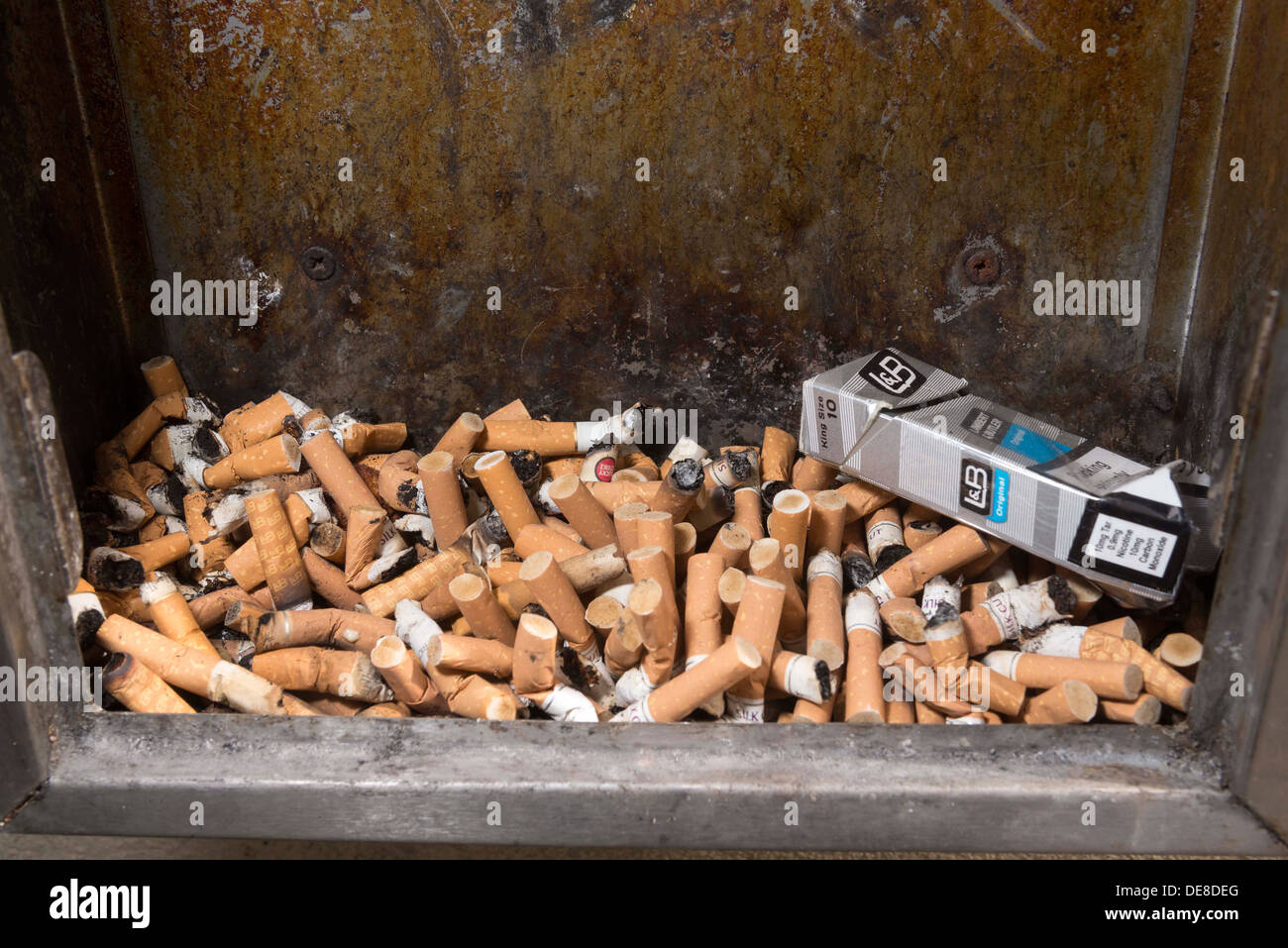 Cigarette ashtray full of stubs. butts.Smoking Damages Your Health. Stock Photo