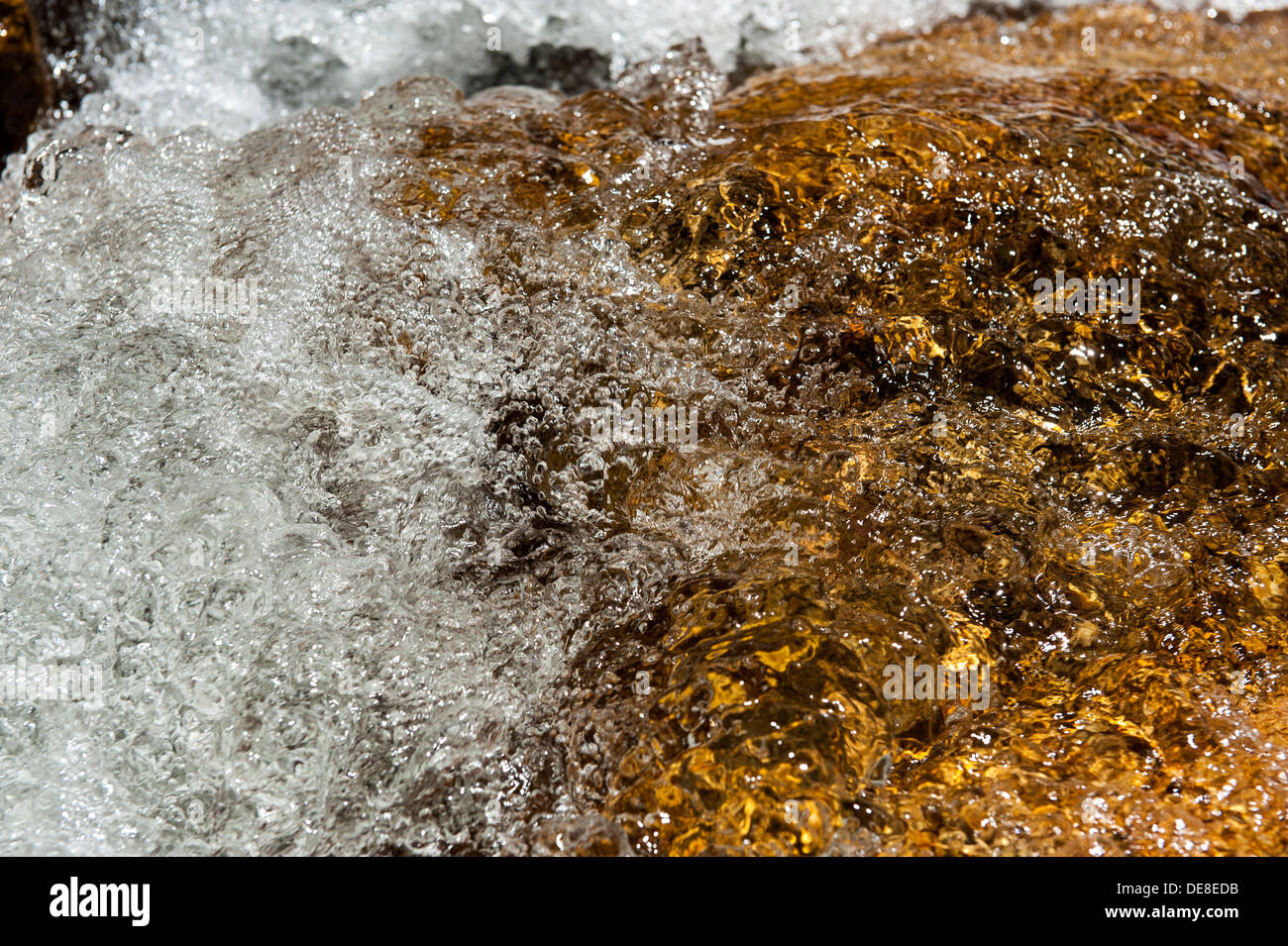 Closeup of a air bubbles in a water stream flowing over a rock, Swartberg mountain range, Western Cape, South Africa Stock Photo